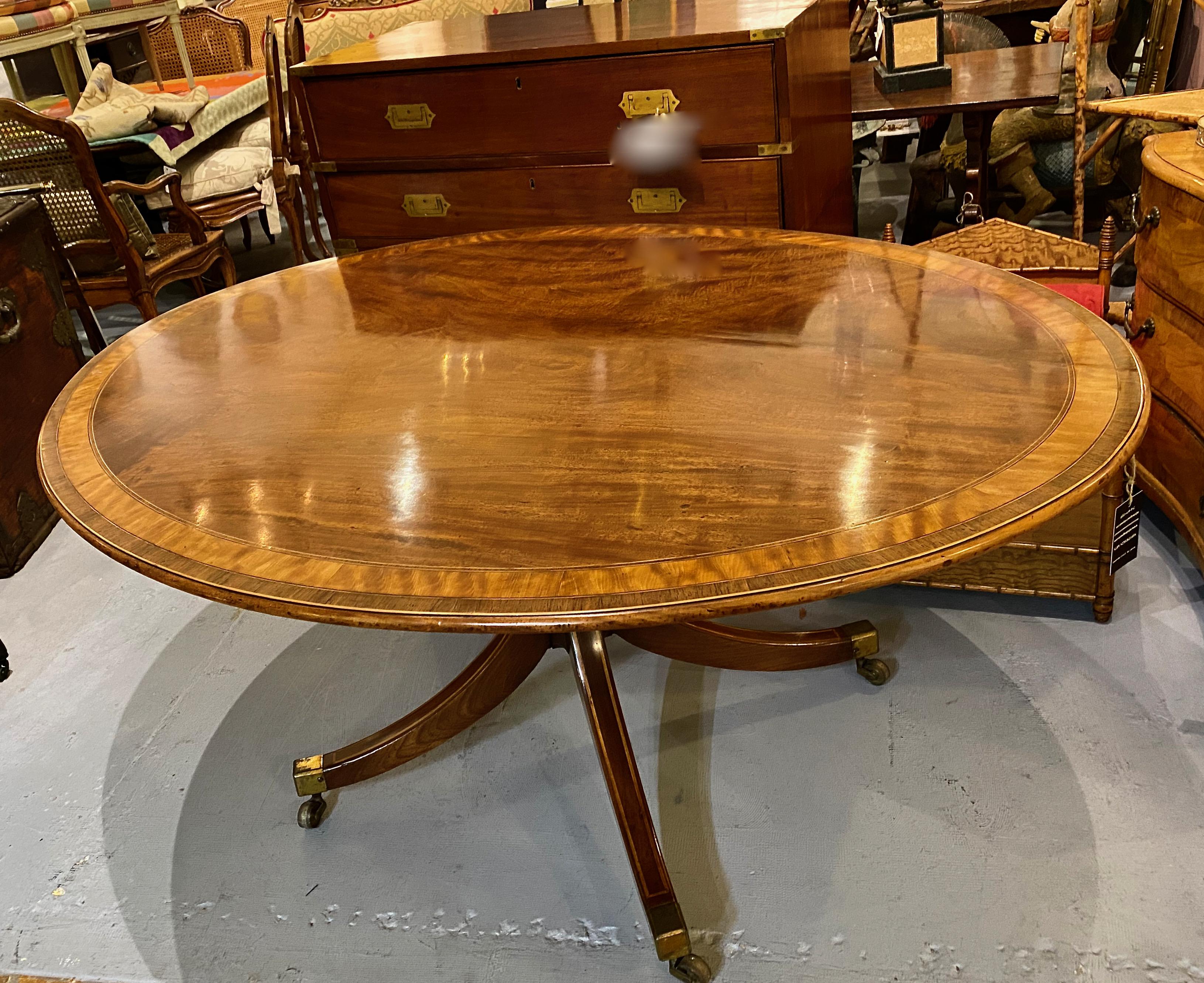 This is a very good example of an elegant, large late George III tilt-top breakfast table. The top is is banded in kingwood and satin wood, with an additional 7 individual lines of inlay. The pedestal features 4 line-inlaid out-splayed legs