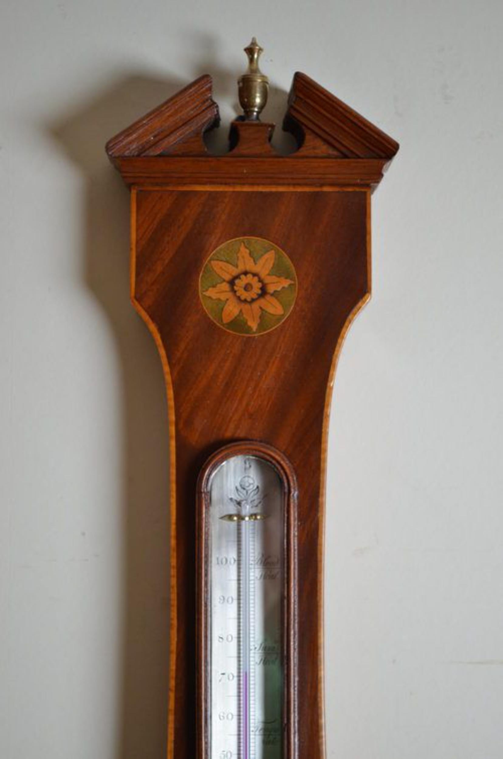 SN2487 Fine quality and very attractive Regency wheel barometer by Ortelli & Co, having silvered thermometer and dial all in mahogany case with floral and shell inlays with triangular pediment with brass finial to top. c1820
Measures: H39