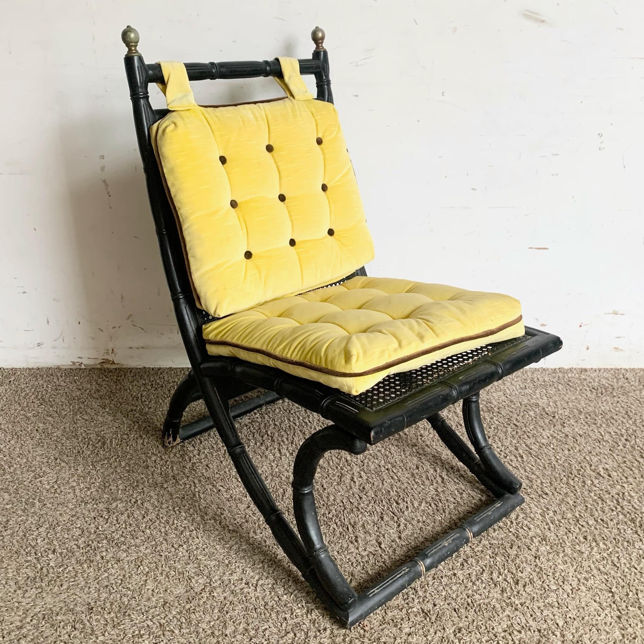 Add a touch of timeless elegance to your space with this Regency black faux bamboo and cane chair, featuring tufted yellow cushions. The chair combines classic Regency design with the charm of faux bamboo and cane, offering both style and comfort.