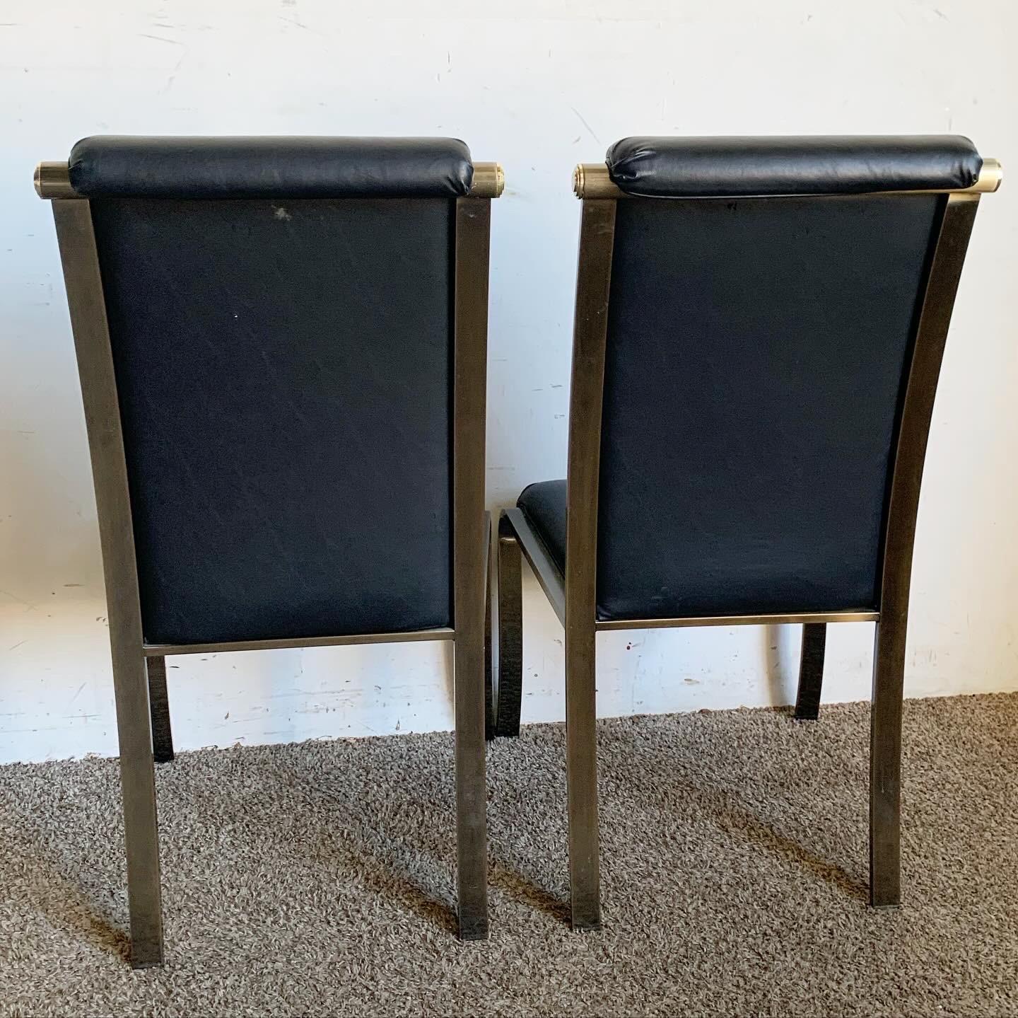 Experience the epitome of elegance with these Regency Black Vinyl Dining Chairs by Design Institute America (DIA). Crafted with a sleek brushed brass metal frame and upholstered in high-quality black vinyl, these chairs blend sophistication with