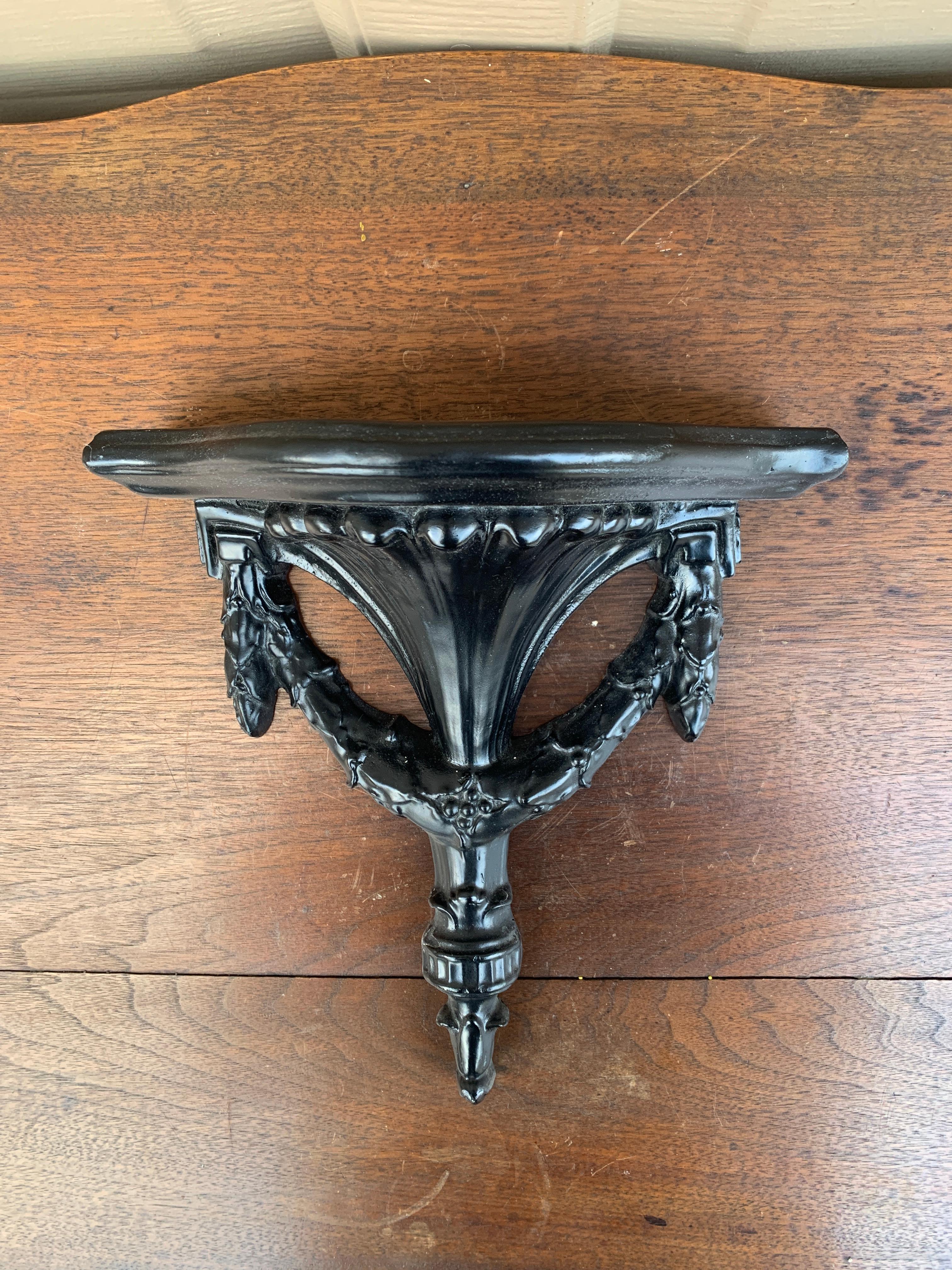 A gorgeous Neoclassical or Regency style black painted wood wall sconce or bracket

USA, Circa Mid-20th Century

Measures: 8.75