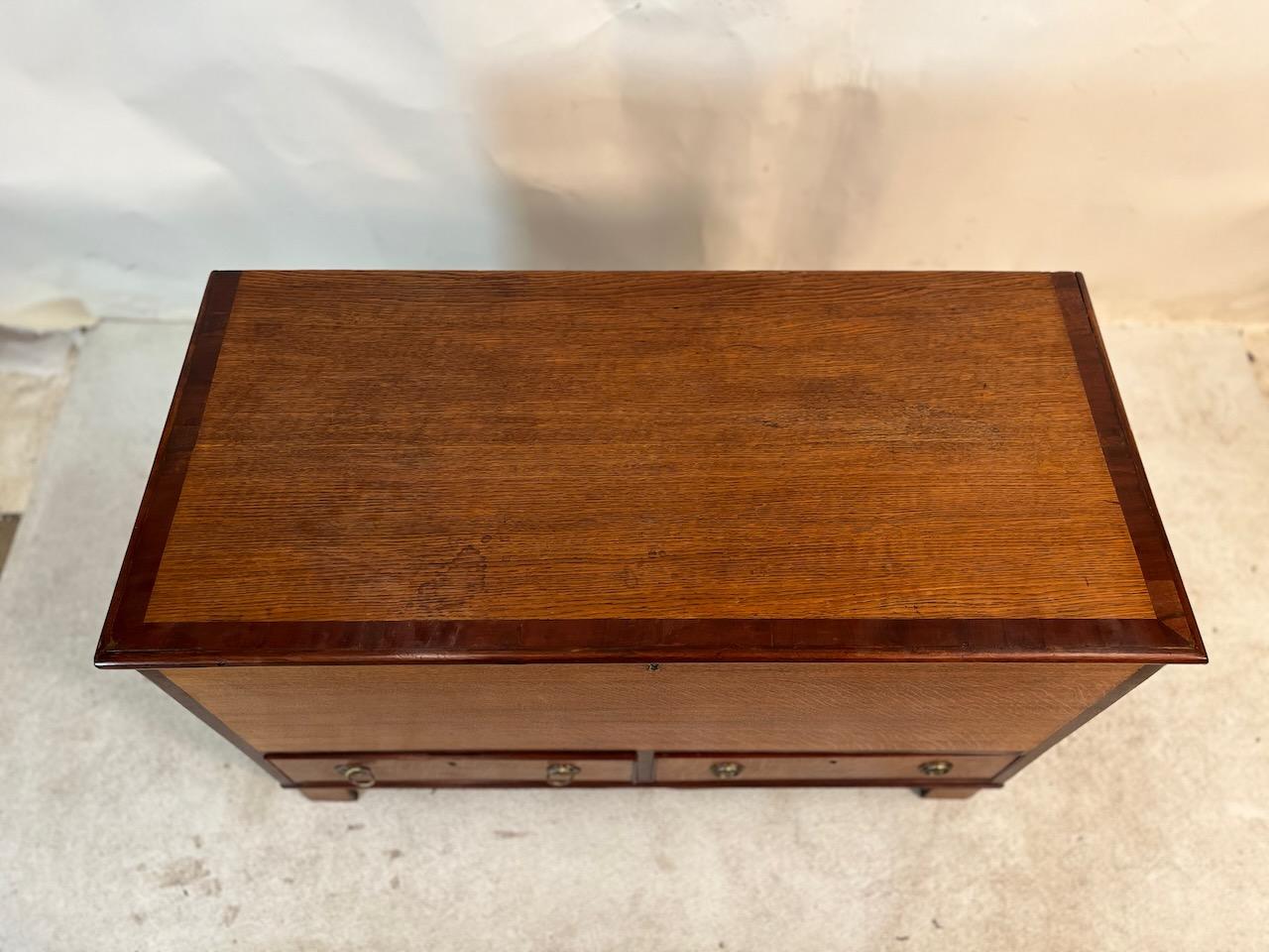 Simple Regency blanket chest.  Satinwood and pine construction with two storage drawers with original brasses.  Beautiful patina with banded lid and front.
Lock with key.

