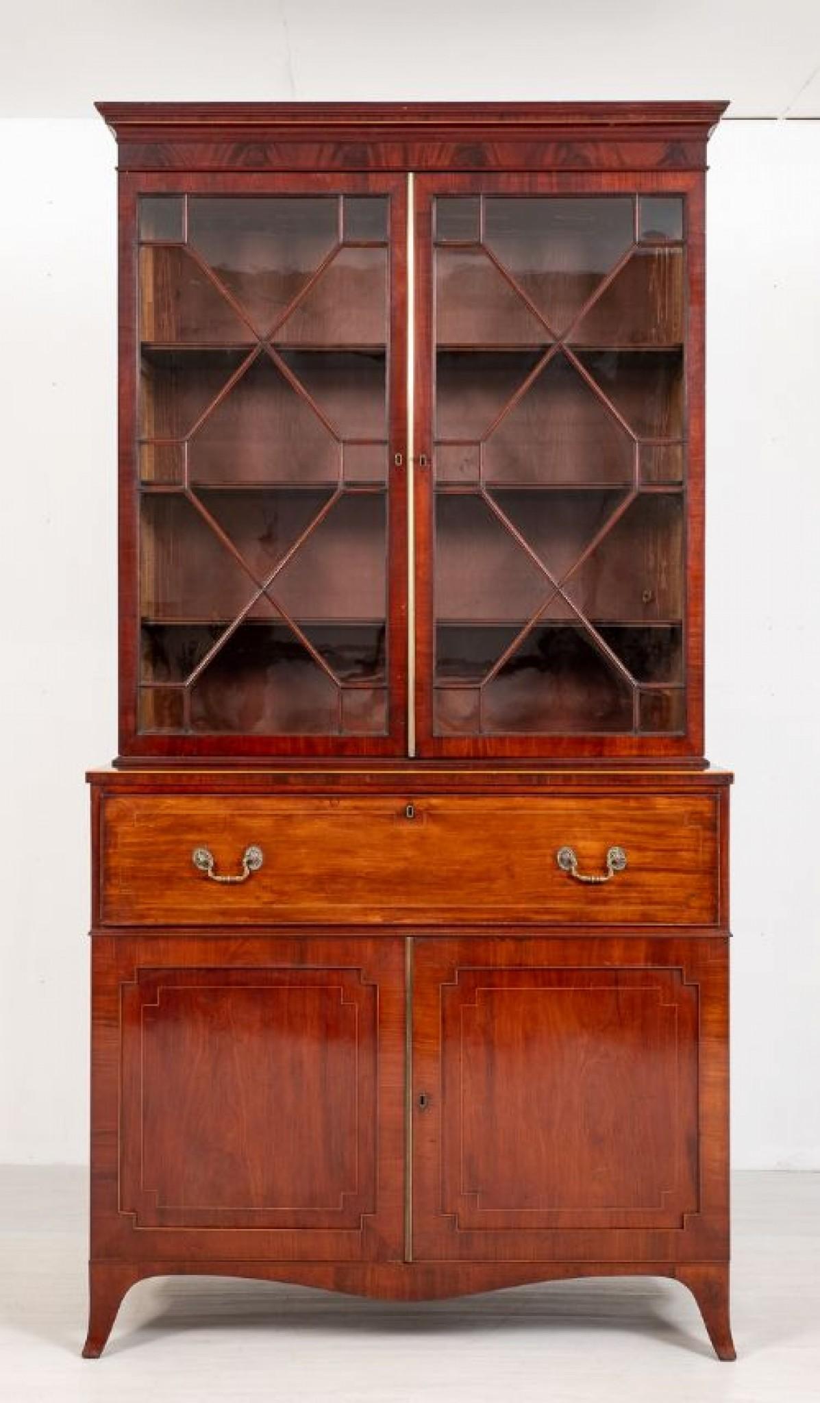 Regency Mahogany Secretaire Bookcase.
This Quality Bookcase Stands Upon Splay Feet with a Shaped Apron.
2 panelled Doors with Boxwood Line inlays the doors open to reveal 2 Sliding Trays.
The Fall Front Writing Compartment having Ebony and Boxwood