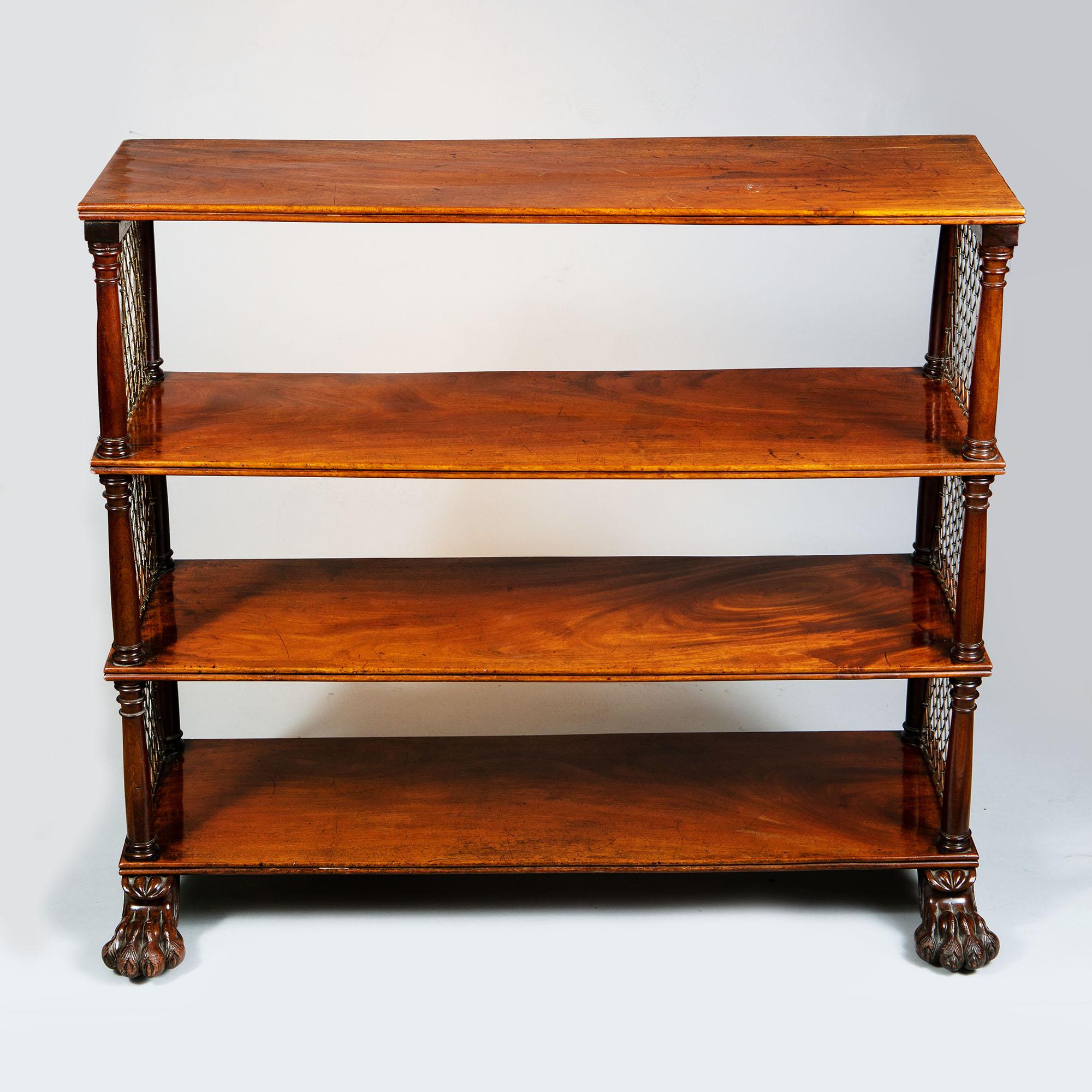 A small Regency bookcase, beautifully crafted with lattice brass on either end. The bookcase is stood on a pair of rather decoratively carved lion paw feet.