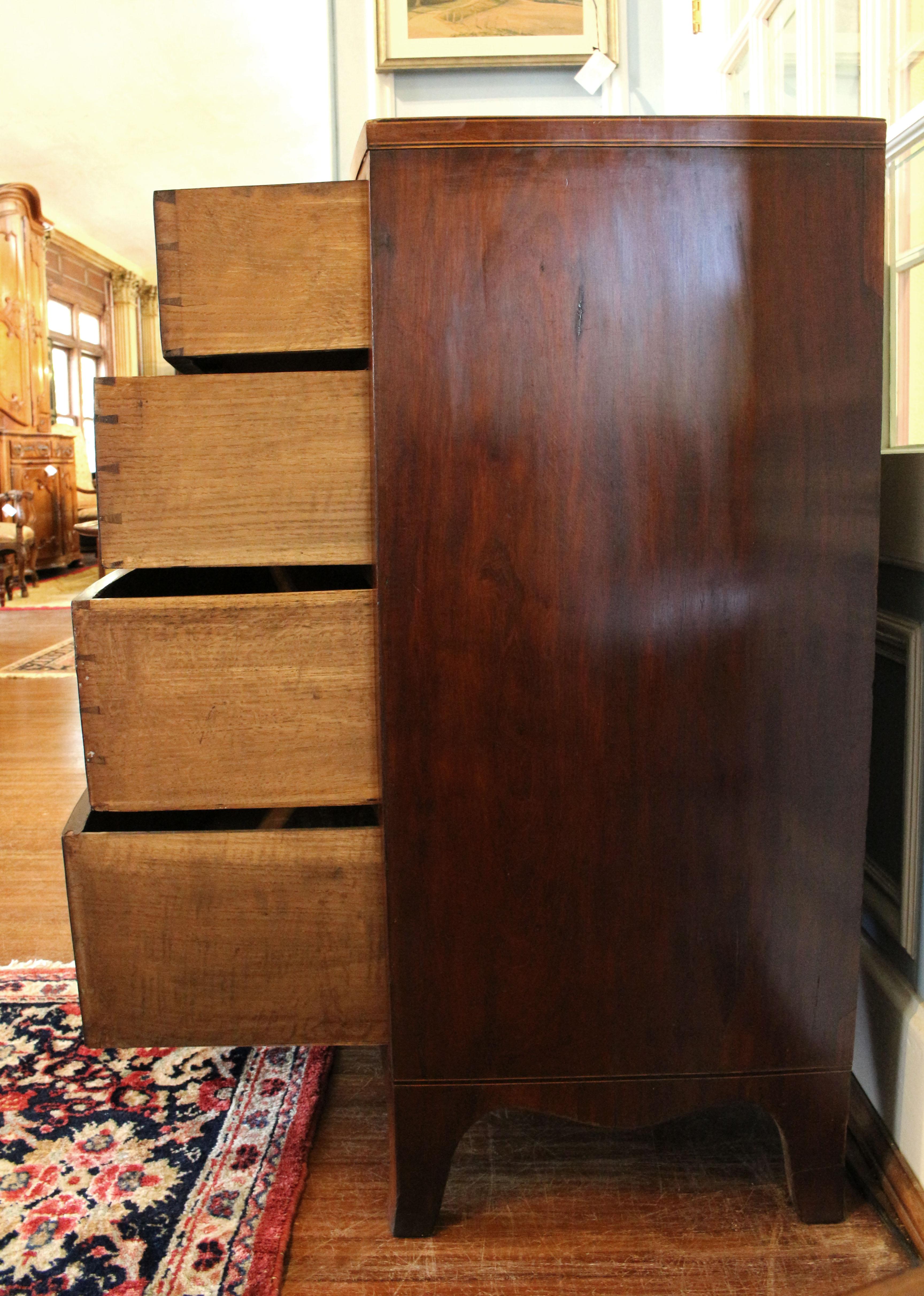 Early 19th century bowfront chest of drawers, English, Regency period. 2 over 3 drawer form raised on French splay bracket feet, shaped apron. Extensive line inlays of contrasting ebony & boxwood and boxwood edging to each drawer. Oak secondary