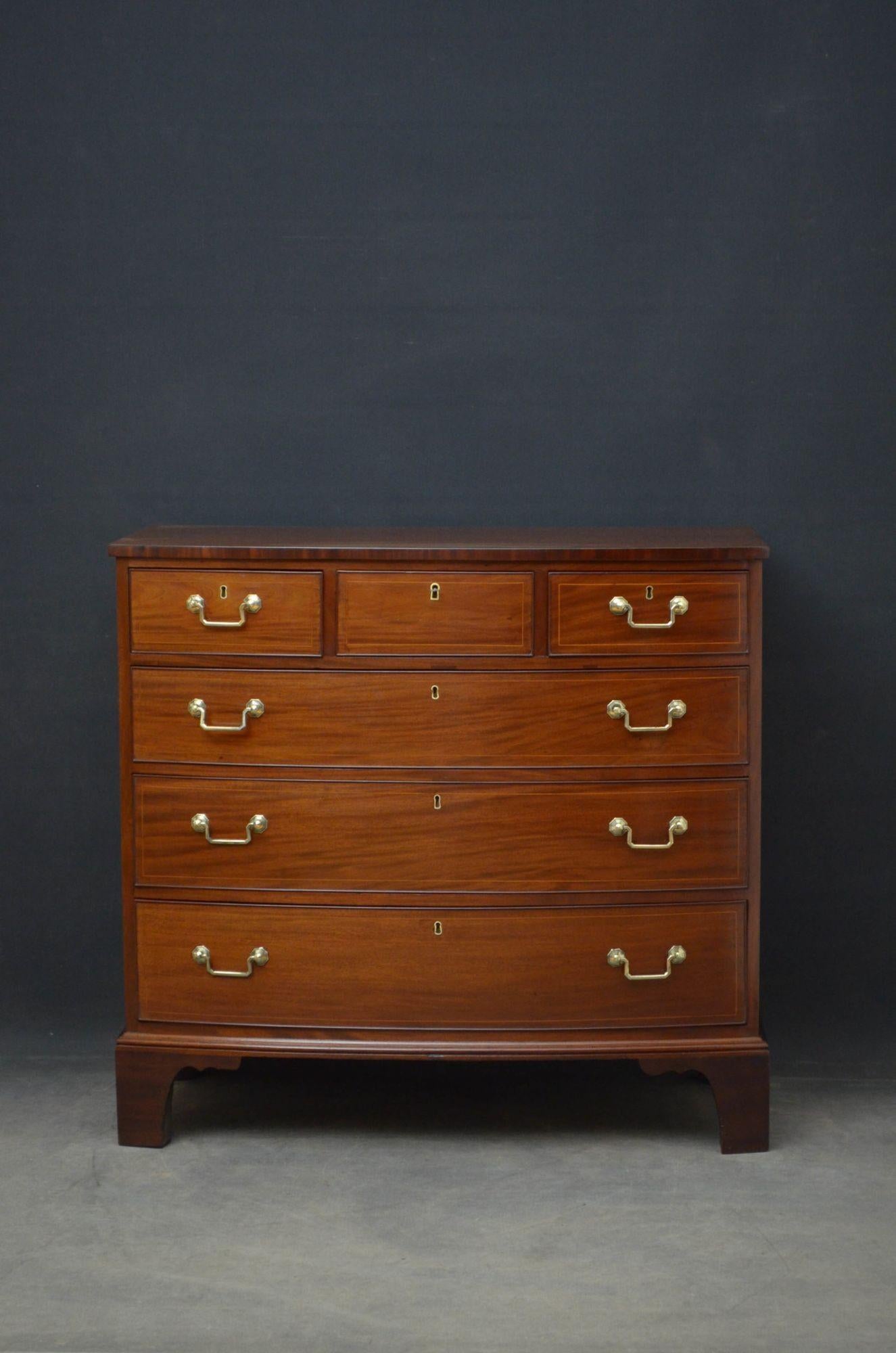 Sn4746, Regency mahogany chest of drawers of bowfronted design, having string inlaid mahogany top above 3 short (key only to open and close centre drawer) and 3 long graduated, cockbeaded and string inlaid drawers, all fitted with original brass