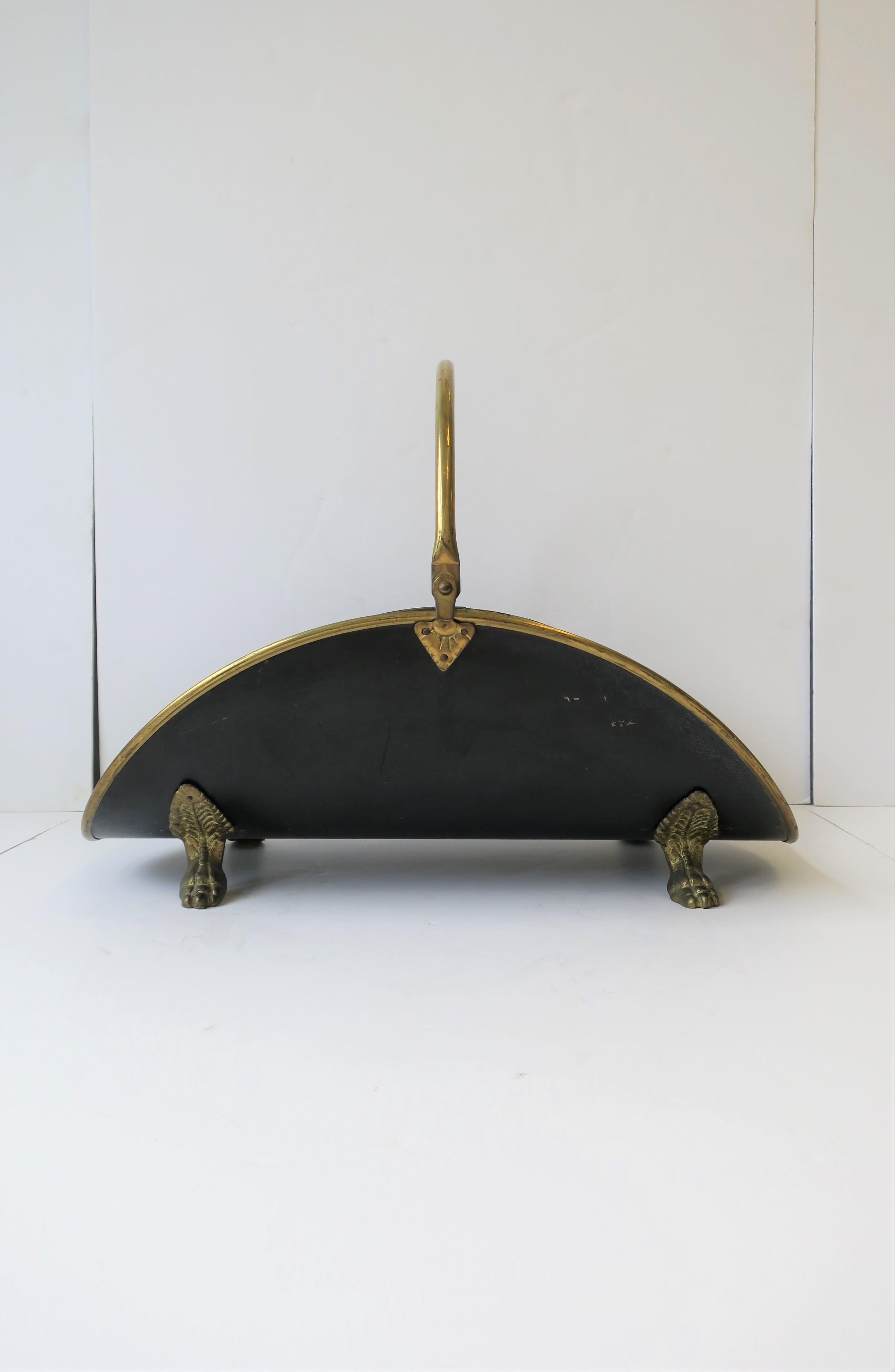 A vintage Regency style brass and black enamel fire wood log holder with paw feet. 

Piece measures: 
16.5 in. H to top of Handle x 22 in. x 13.75 in.


 