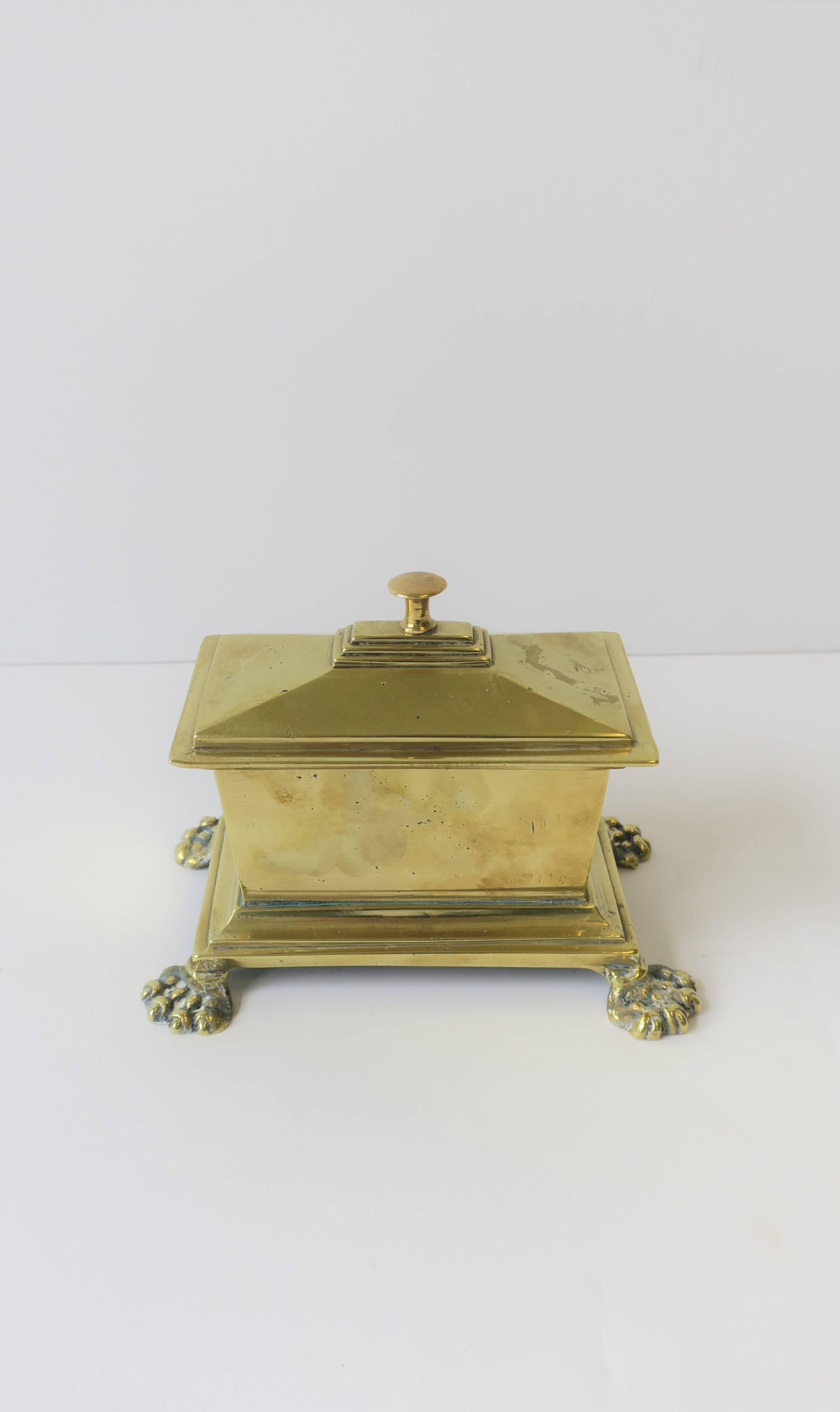 A beautiful and substantial brass box with lion paw feet in the Regency style, circa mid-20th century.

Box measures: 5.75 in W x 3.75 in. D x 4.75 in. H

 