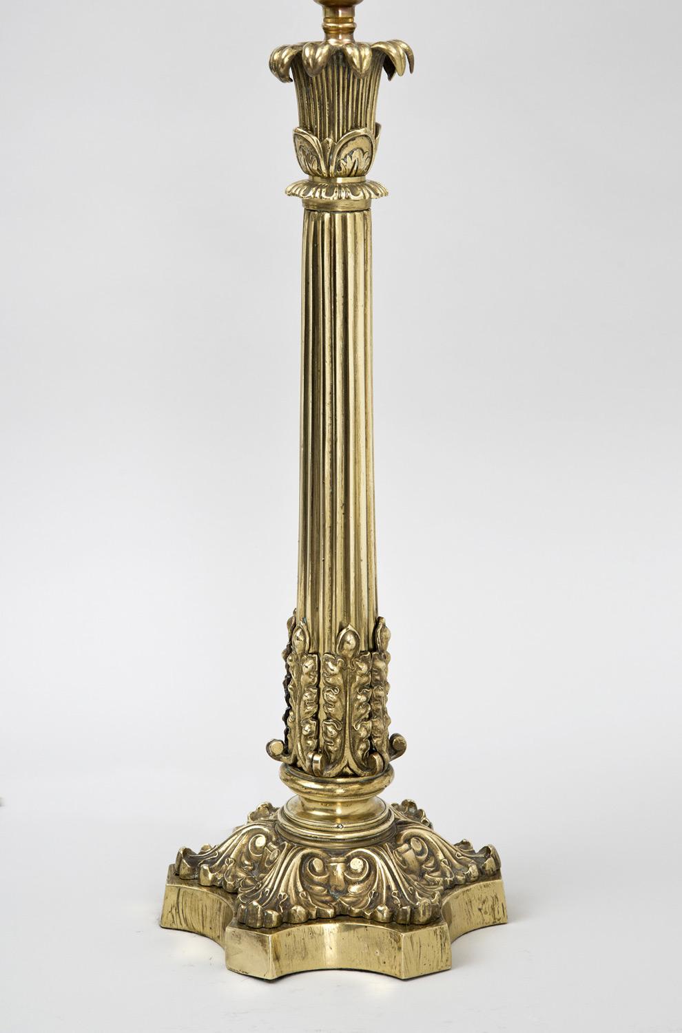 Regency brass lamp, the top decorated with curved leaf motif, the bottom of the reeded column is surrounded by acanthus leaves, the six-pronged lobed base also with bold acanthus leaf decoration. This lamp is of exceptional quality.