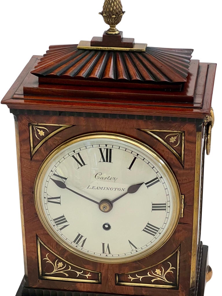 A small sized Regency brass inlaid mahogany eight day timepiece bracket clock made by Carter from Leamington Spa, England in the 1820's.

The case is of an attractively smaller size with beautiful proportions. The mahogany is richly figured with a