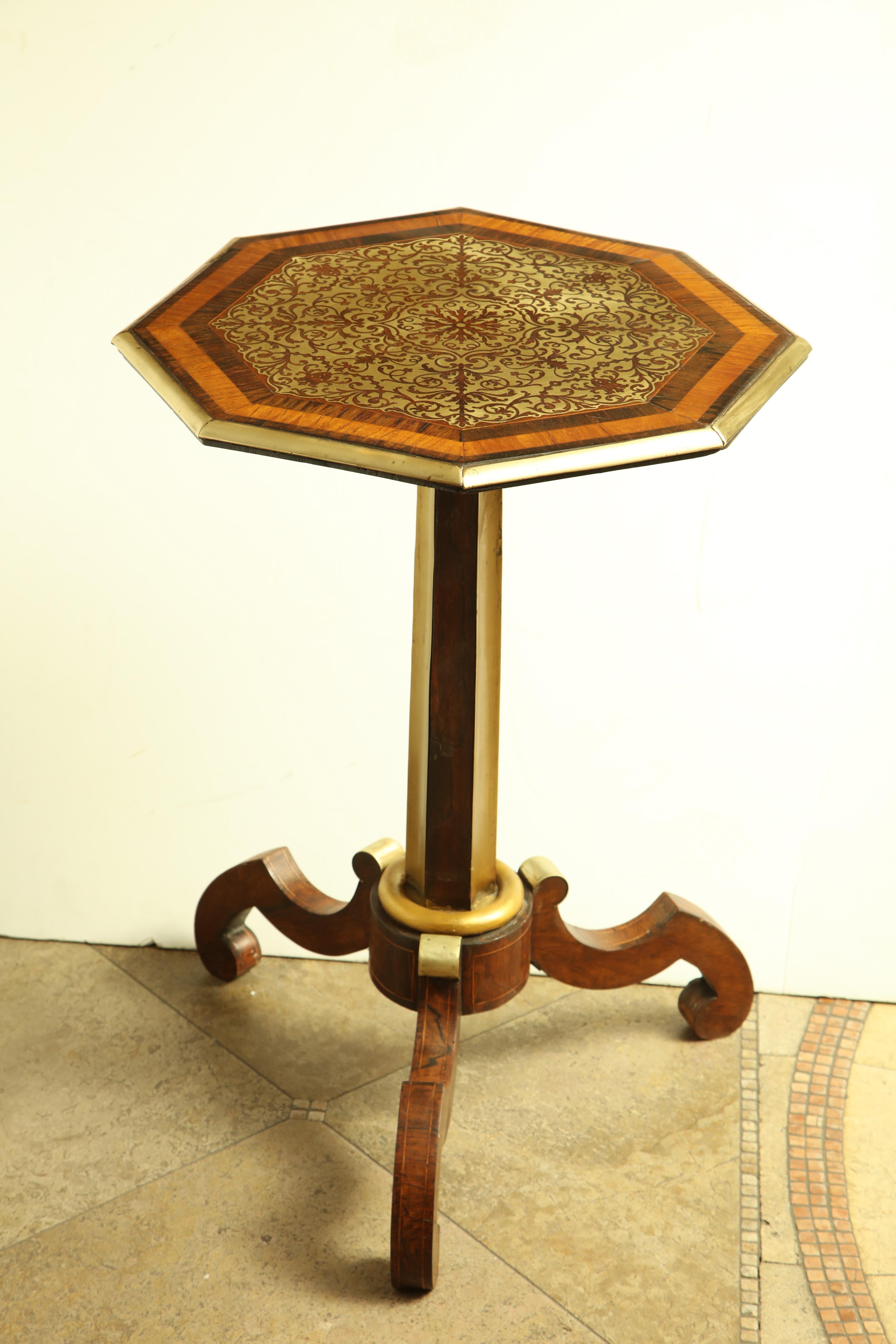 A fine Regency brass inlaid mahogany pedestal side table with an elaborately inlaid octagonal top and with gilt accents.