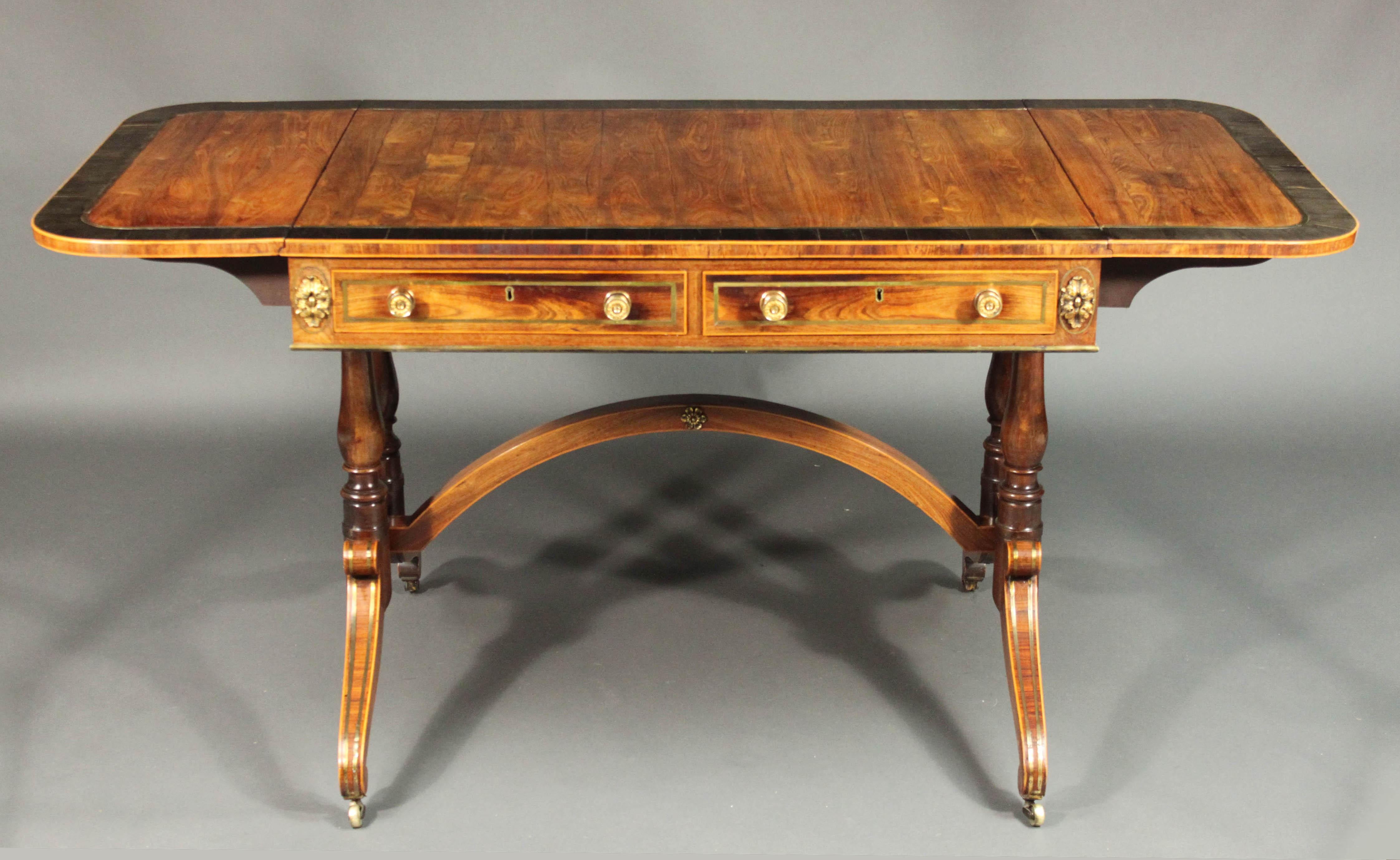 Regency standard-end brass inlaid sofa table in kingwood with Fine ormolu mounts and ebony and boxwood inlay; 2 oak-lined drawers with boxwood cockbeading.

Kingwood is often used in small pieces for crossbanding and inlay but it is rare to find a