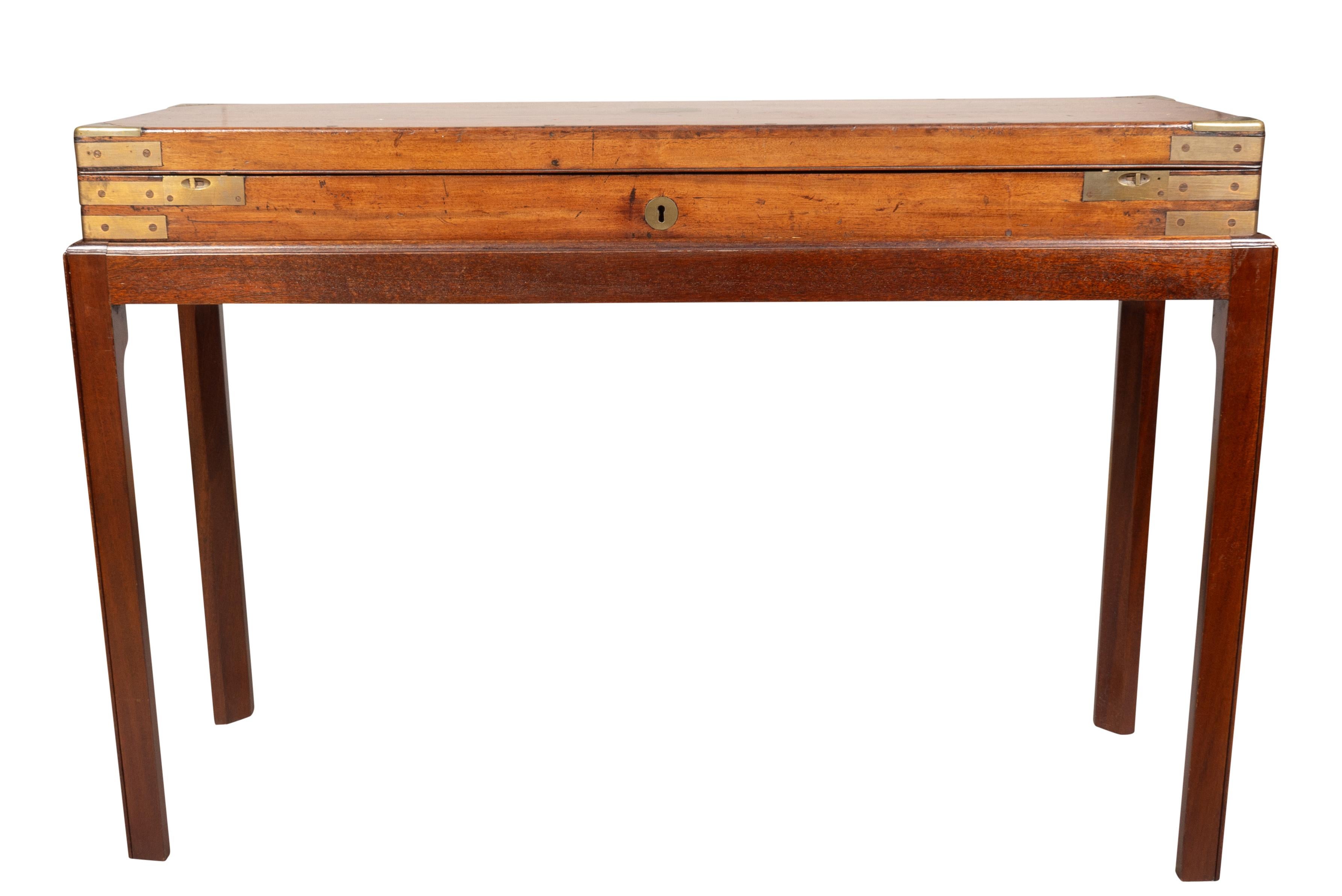 Brass mounted hinged rectangular box with fitted interior on a later mahogany base with square section legs.