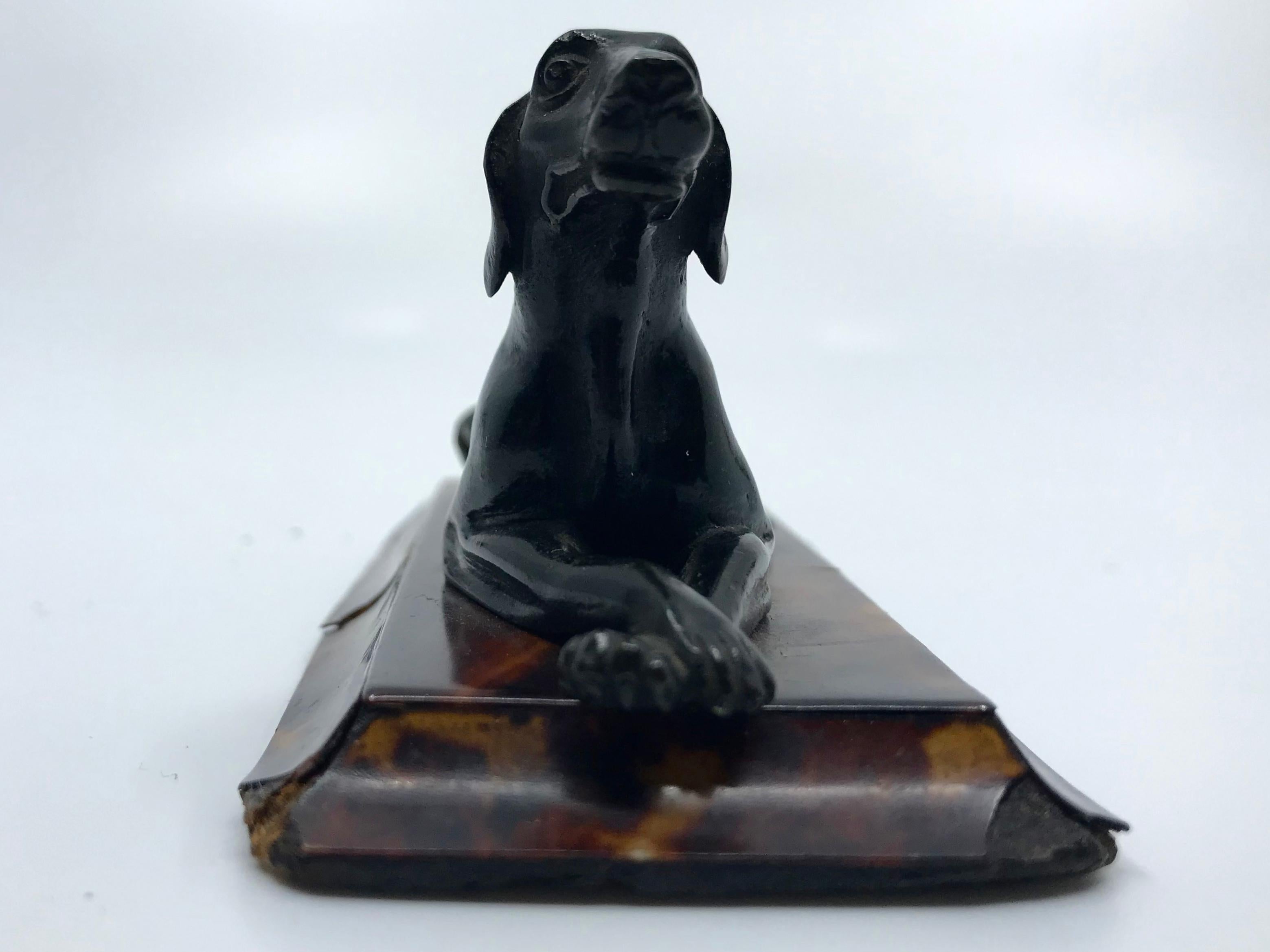 Regency bronze hound dog sculpture on tortoiseshell base. English bronze hunting dog sculpture on original low sculpted plinth base sheathed in tortoiseshell, England, 1820’s.
Dimensions: 4.38” W x 2.13