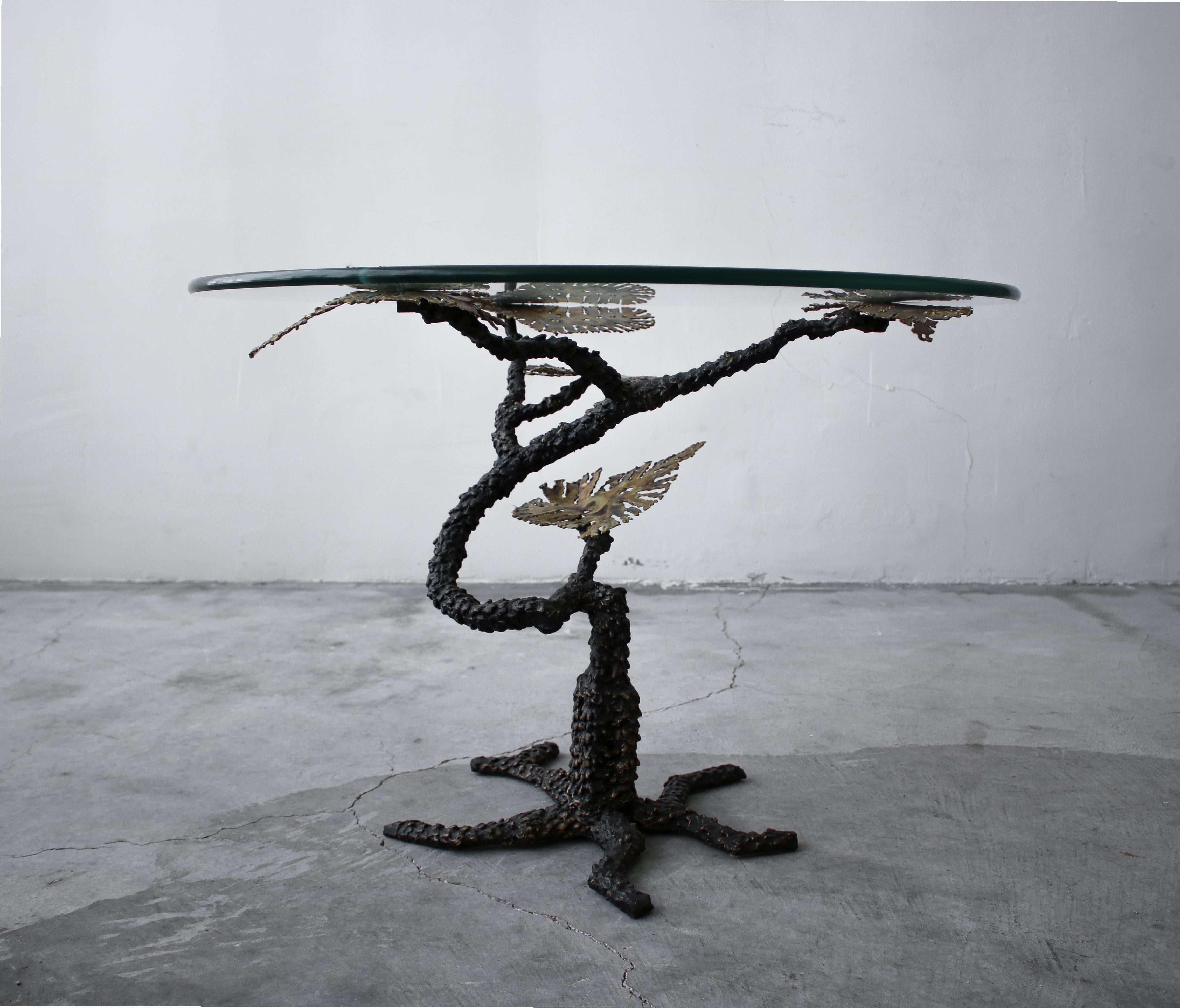 Beautiful Brutalist bronze and glass tree side table. The top 3 leaves screw through the glass adding to the dimensional interest. A piece with form and function. 

Table is in excellent vintage condition with no damage to be noted.