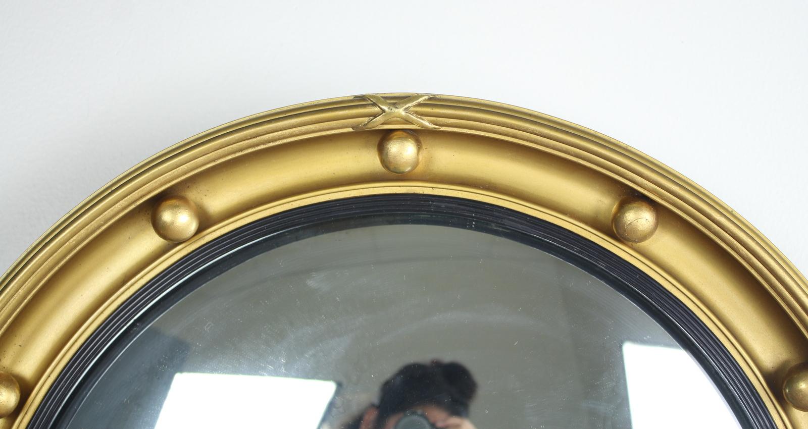 A turn of the century wood and gesso frame, with a ribbed and ebonized inner band. The gilt finish is in very good antique condition, and the original glass is also. A glamorous look!