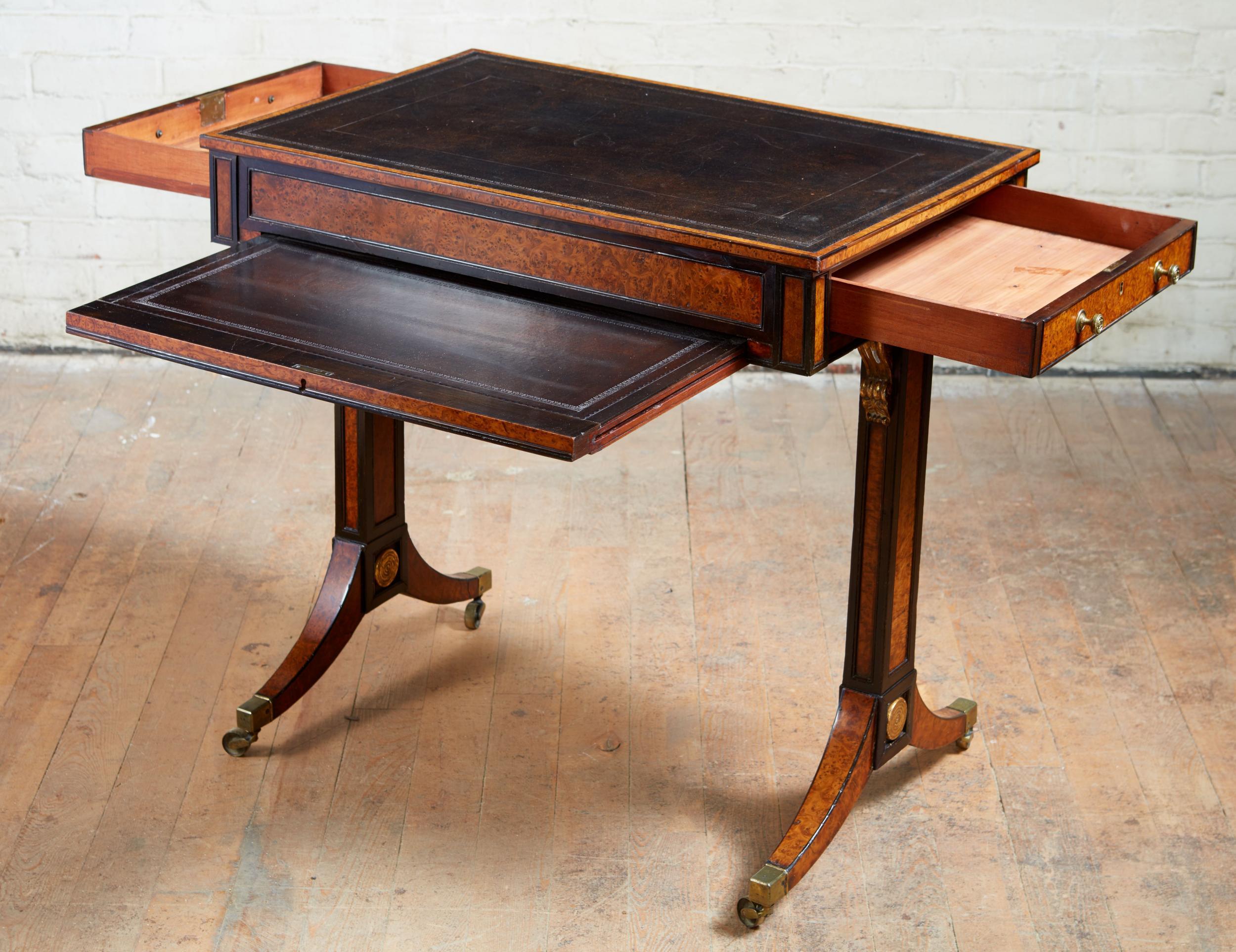 Fine Regency period burr oak and ebony writing table in the manner of George Bullock, the leather lined top with gilt tooling and burr oak and ebony banding, over two cedar lined drawers having ebony moldings and adjustable writing slope also with