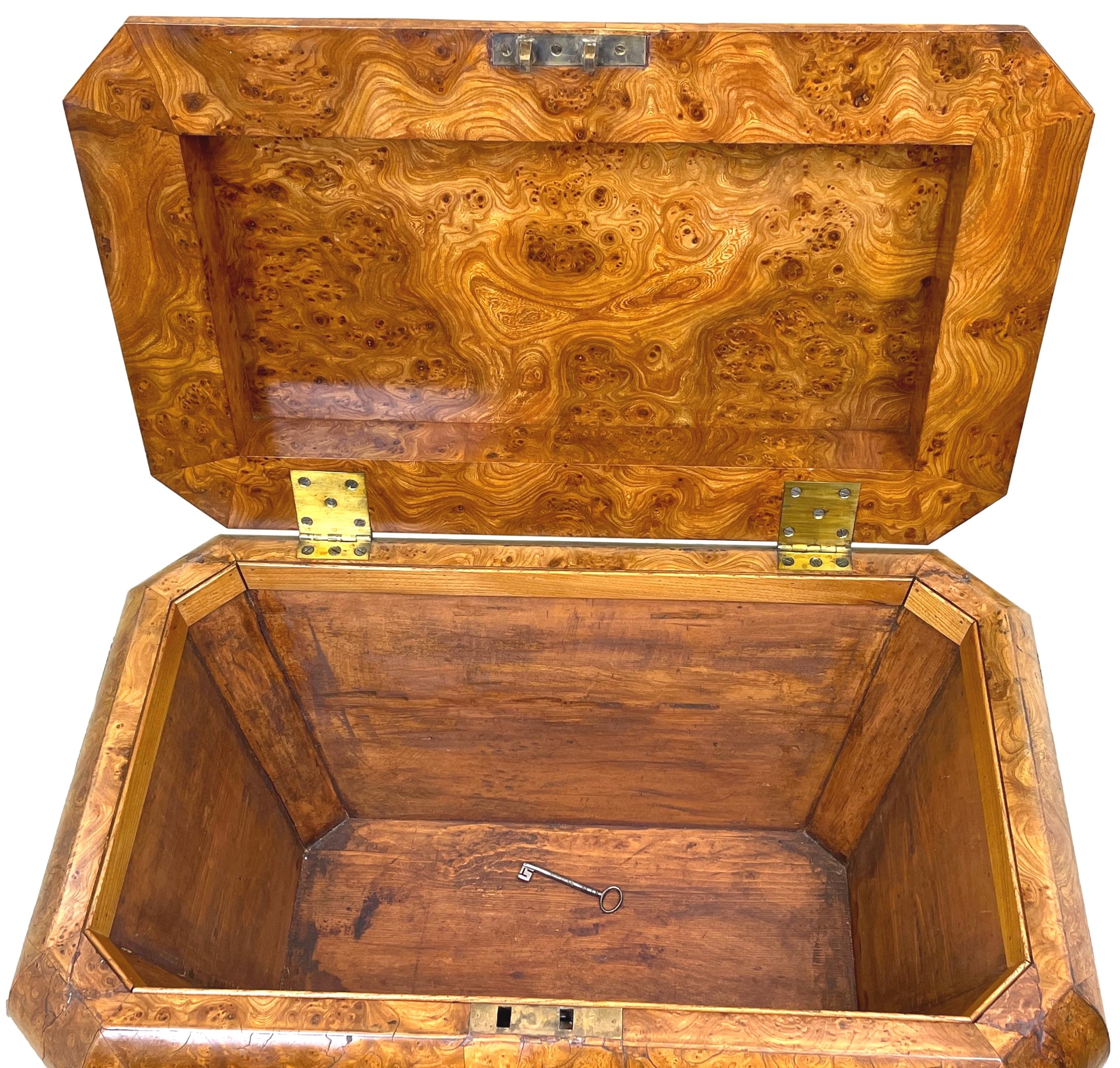 An Exceptionally Rare Regency Period Burr Elm Cellarette, Or Wine Cooler, Of Sarcophagus Form Having Lift Up Lid With Original Brass Hinges And Rich Foliate Carved Decoration Standing On Original Tablet Feet.

Cellarettes, often referred to as
