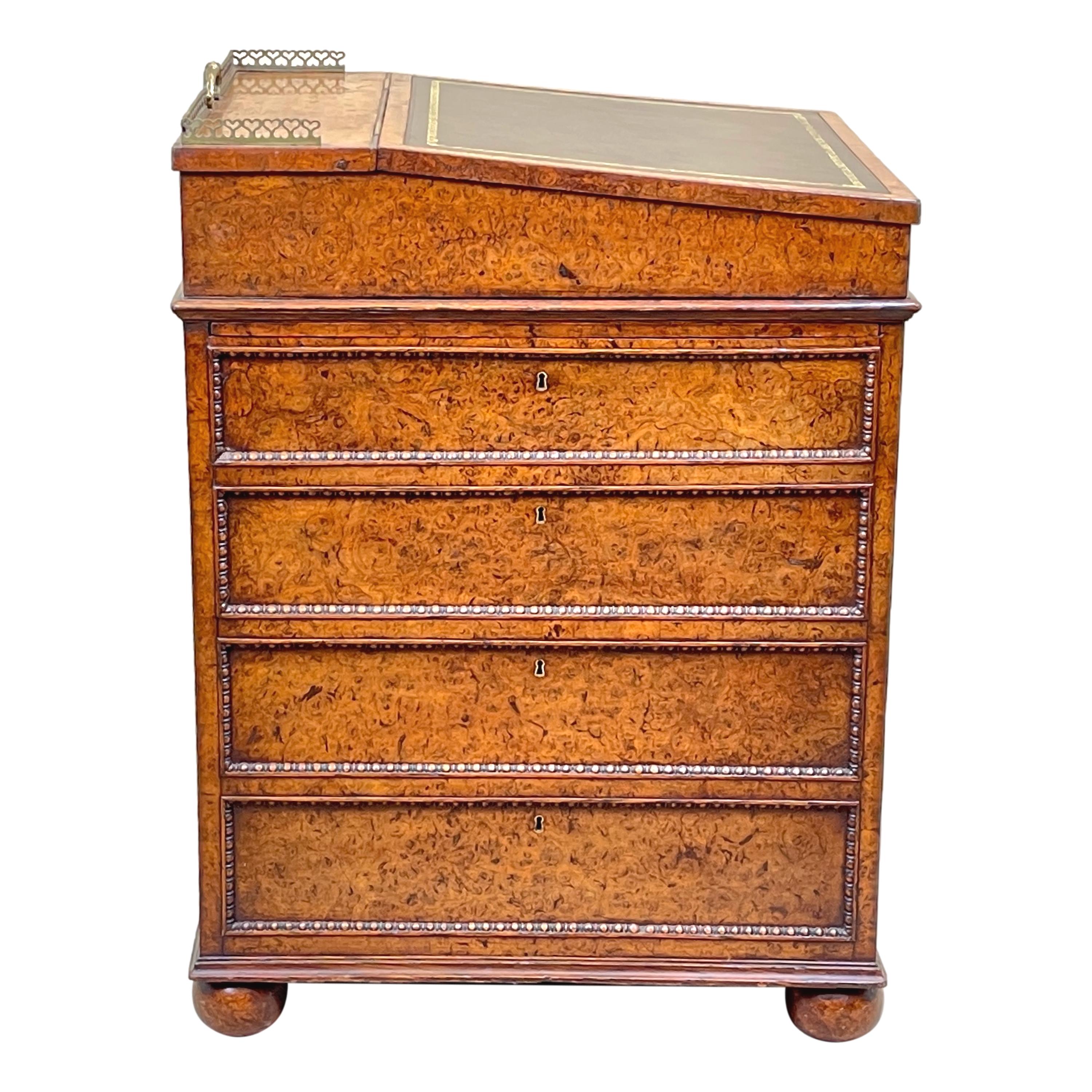 An Exceptional Quality And Extremely Rare Early 18th Century Regency Period Burr Elm Davenport Having Hinged Swivel Top With Inset Leather, Retaining Elegant Original Ormolu Gallery With Pierced Handle, Over Rare Mechanical Slide And Four Ash Lined