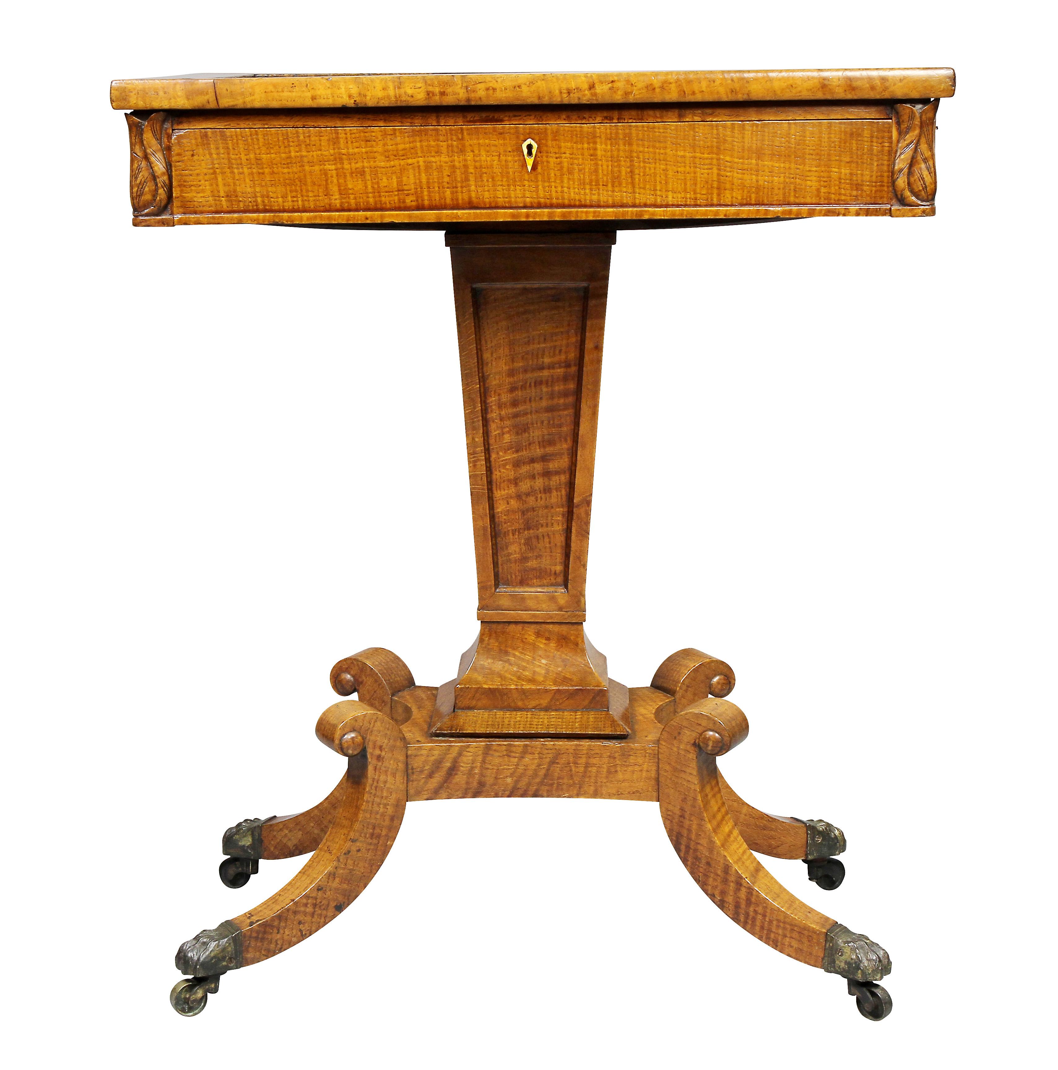 Rectangular inset marble with various types within a raised banded edge, over a drawer and tapered support, and four saber legs with casters.