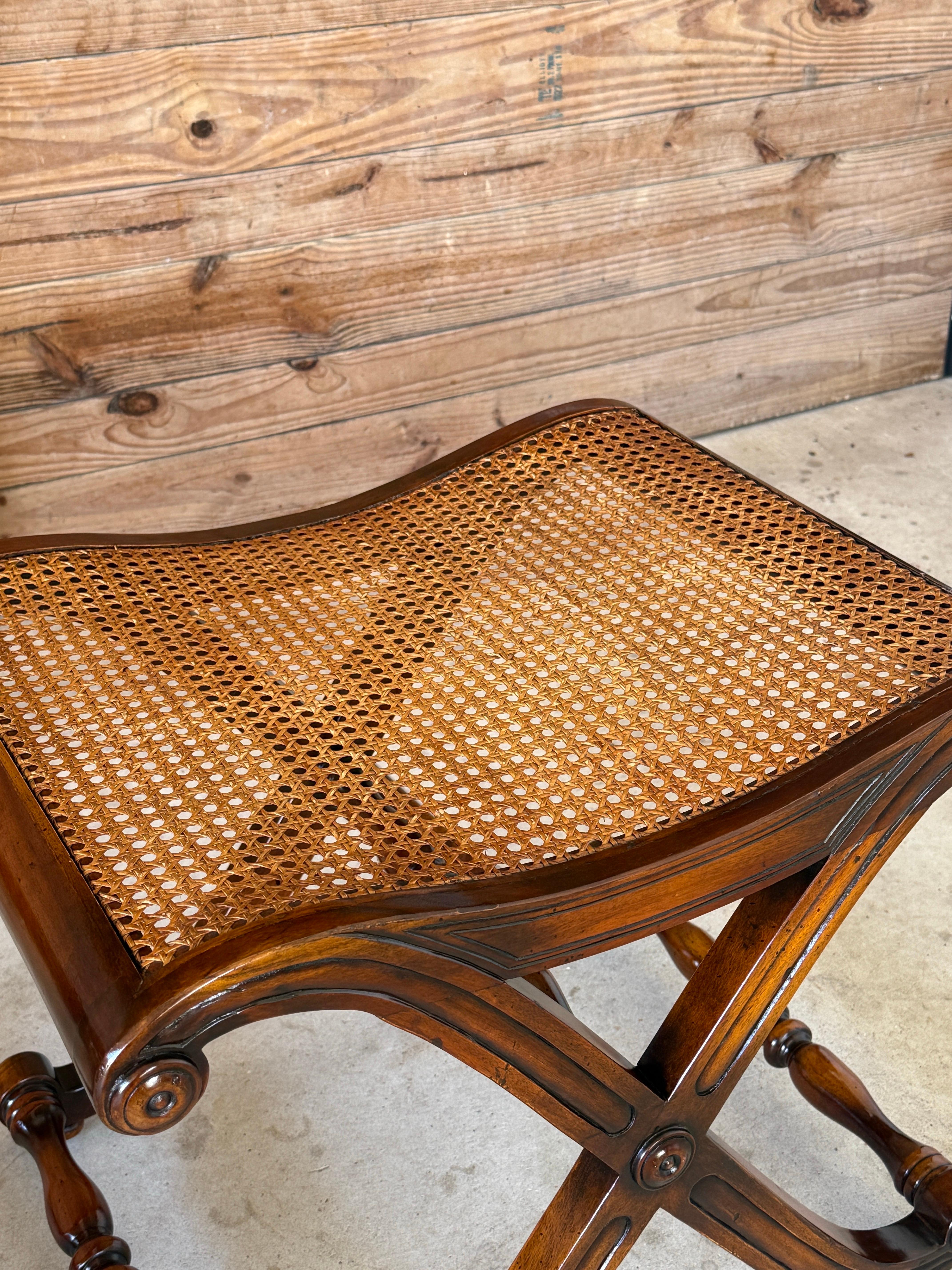 A refined pair of Campaign-style stools featuring elegant X-base frames and handwoven cane seats, in the manner of Gillows of Lancaster.
These stools showcase turned stretchers, scrolled details, and a graceful silhouette reminiscent of English
