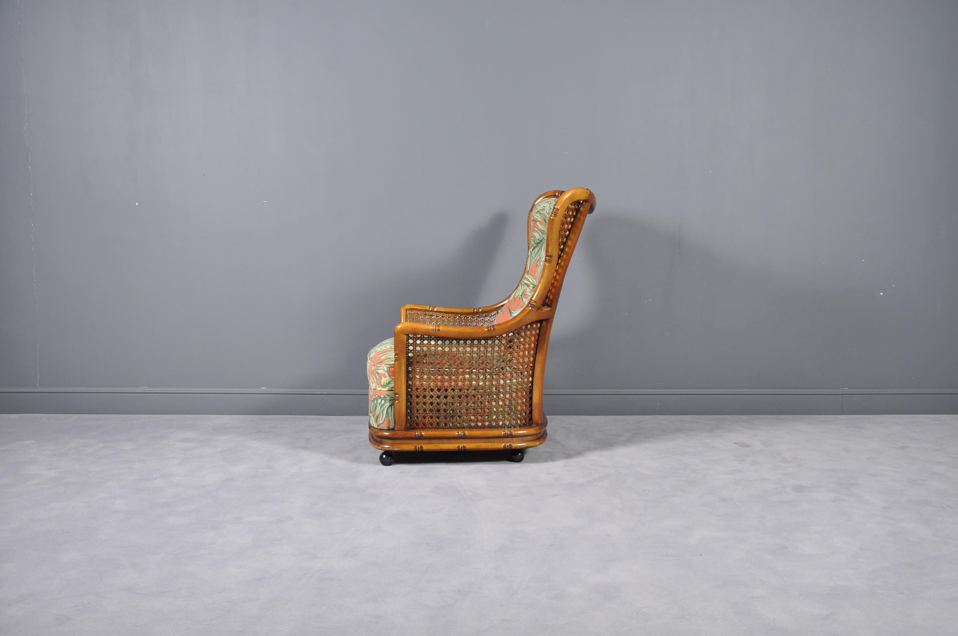 Regency caned bamboo armchair on wheels, 1970s.