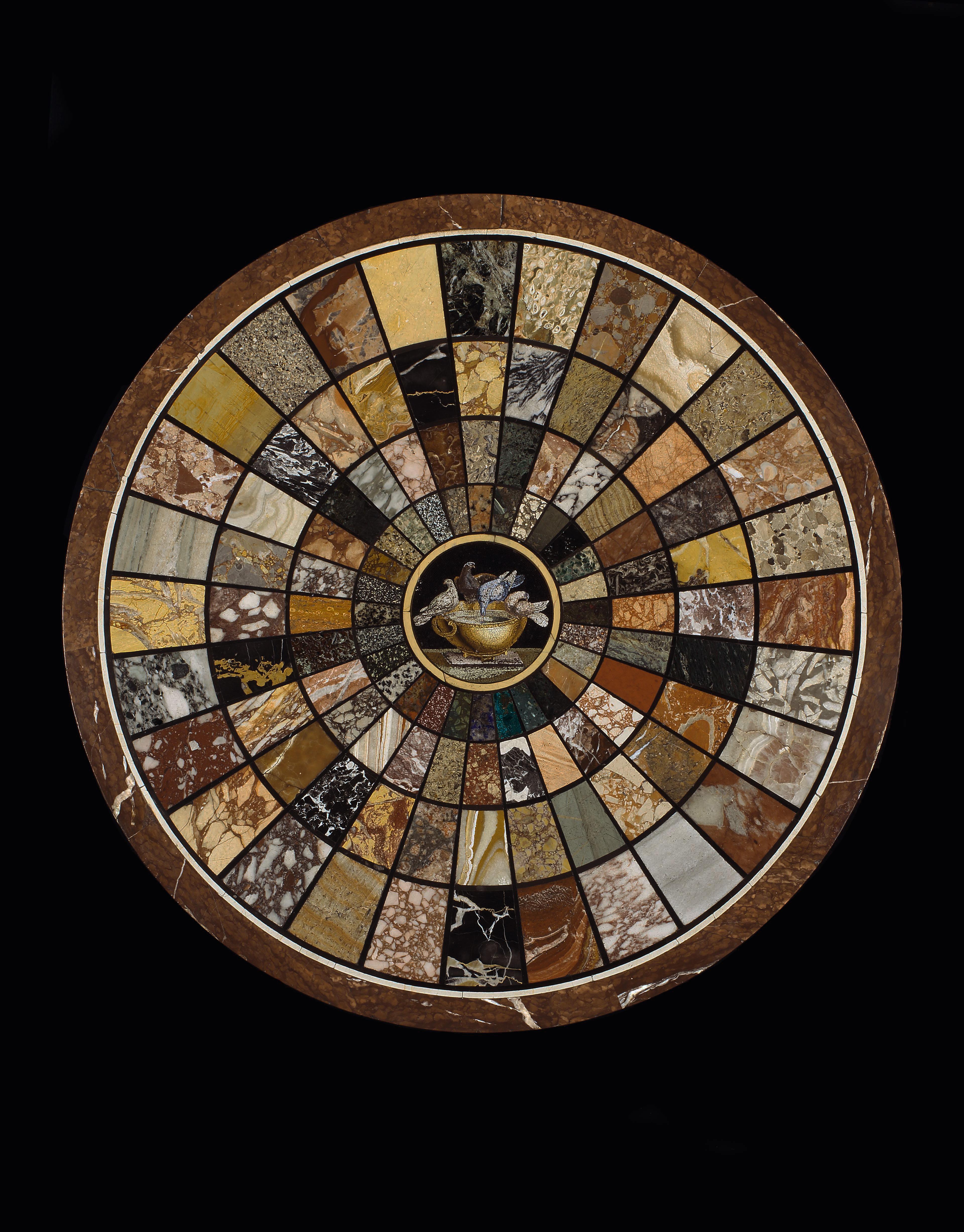 A superb Regency circular centre table, the specimen marble top inlaid with radiating panels of 112 various marbles and hard stones including Malachite, Lapis-Lazuli and Harlequin Breccia, all centred by a micro mosaic panel depicting ‘The Doves of