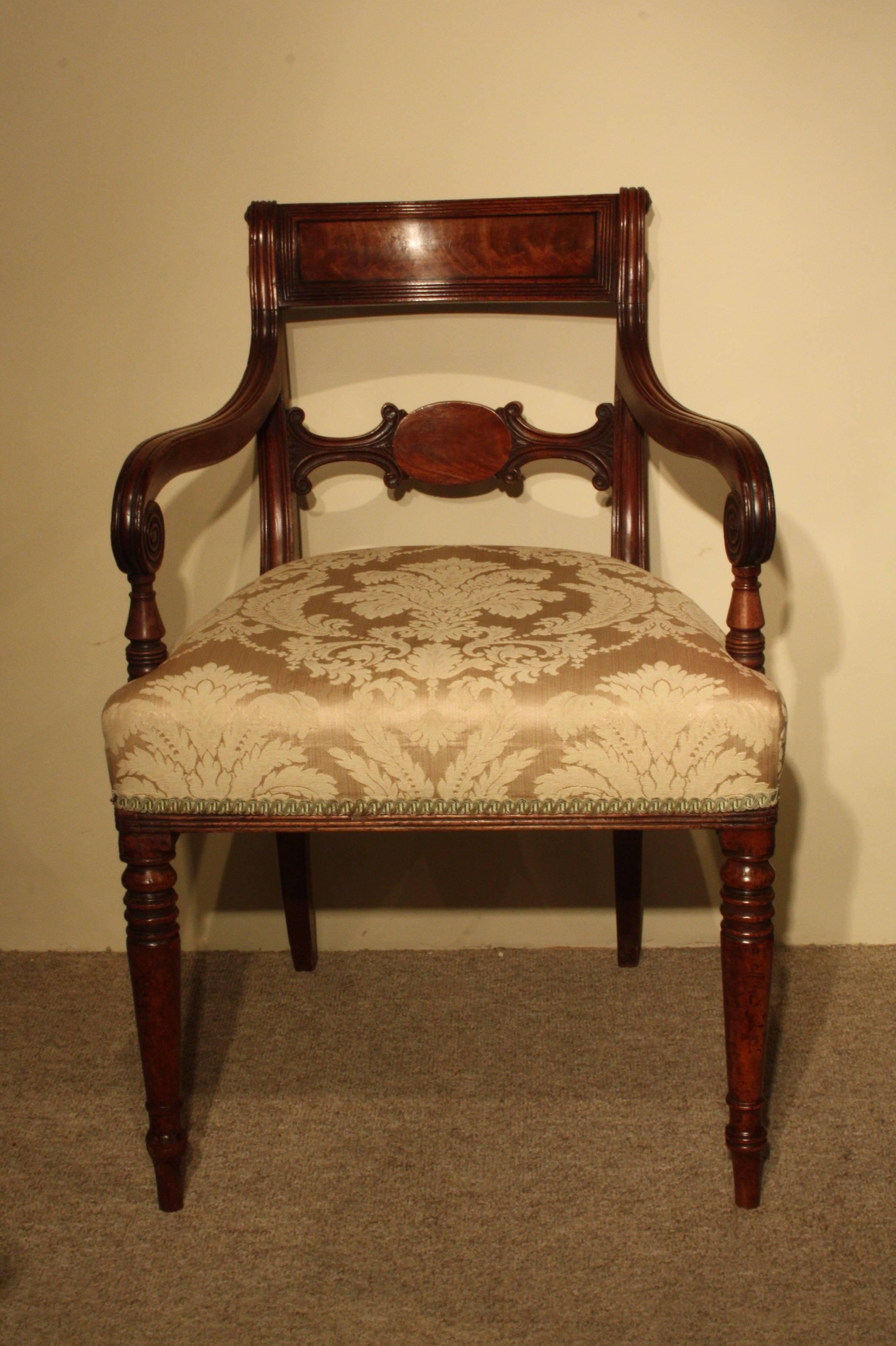 Regency mahogany carver armchair of small proportions upholstered in a light gold damask fabric.