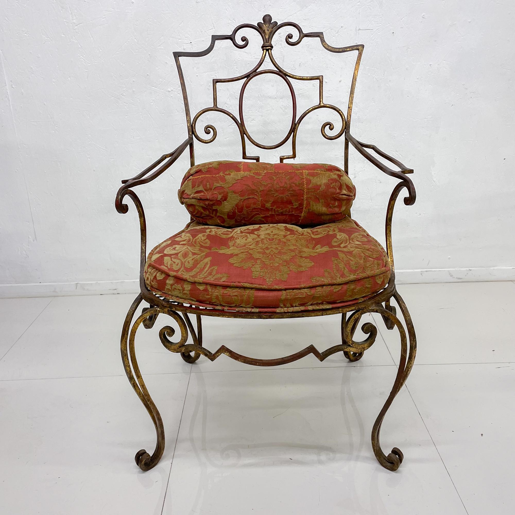 Hand forged accent chair
Spectacular Regency chair Italian gilt over iron hand forged flair attribution style of Arturo Pani 1950s 
37.75 H x 23.5 W x 24 D and Seat H 19 inches with cushion, 16 without. Arm 24 inches
Original Italian