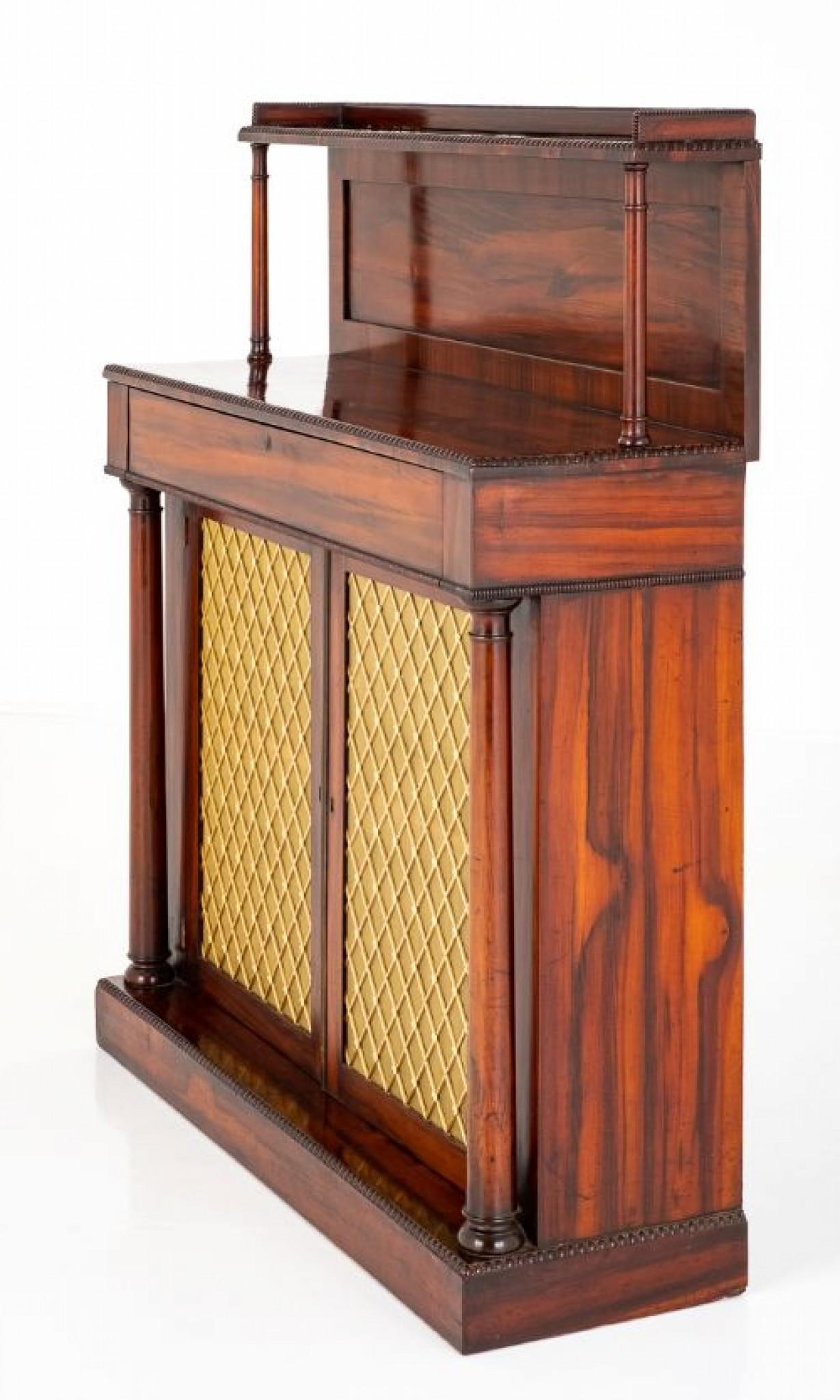 Here we have a good quality regency rosewood chiffonier.
Standing upon a plinth base.
The 2 doors having gilt lattice grills with pleased curtains behind and open to reveal 1 loose shelf.
The doors are flanked by turned pillars.
Featuring 1