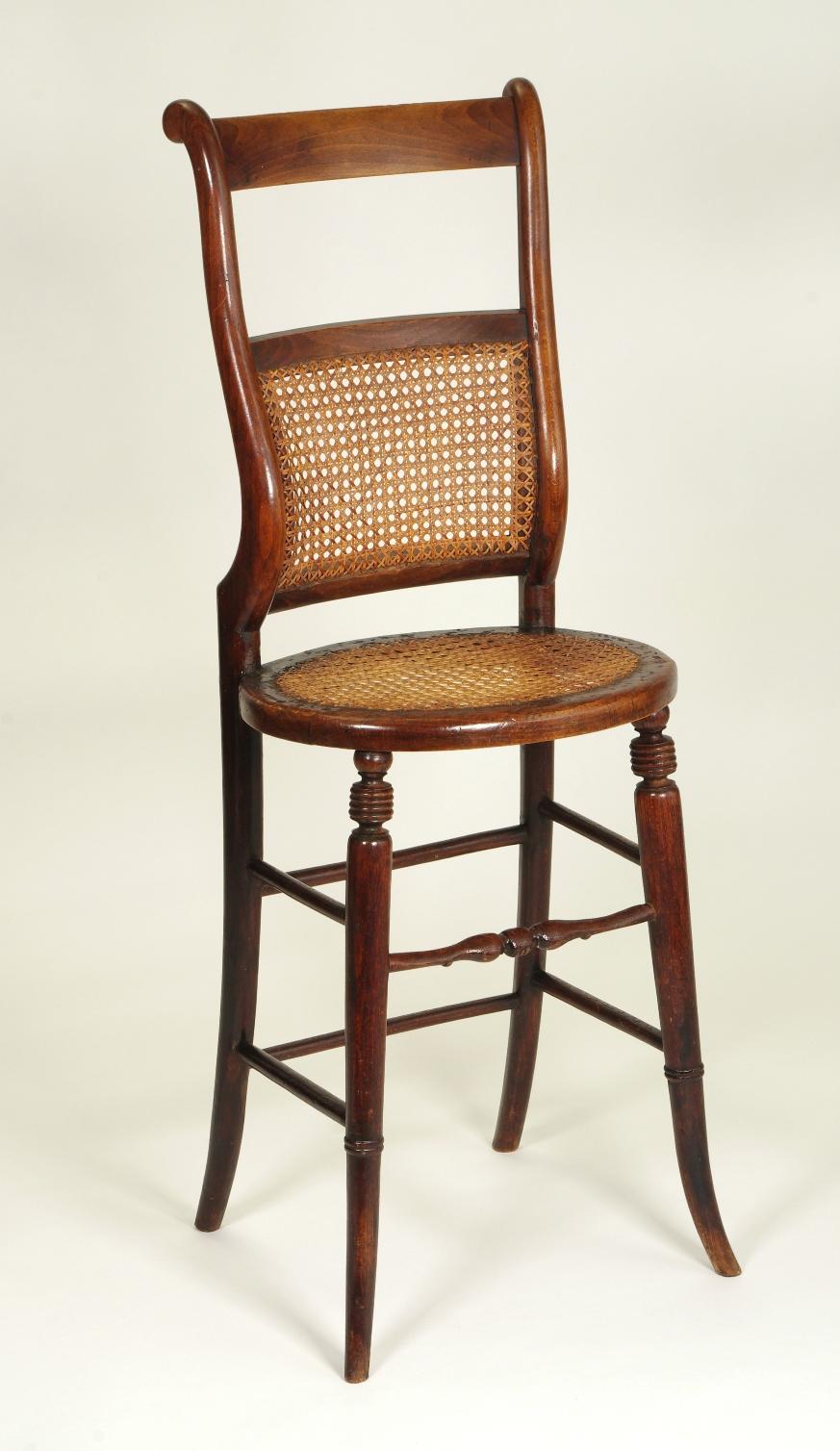 Regency beech child's correction chair, the caned seat and back raised on tall sabre legs joined by numerous stretchers.

The original time-out chair, chairs of this type are known by many names: discipline chairs, punishment chairs and correction