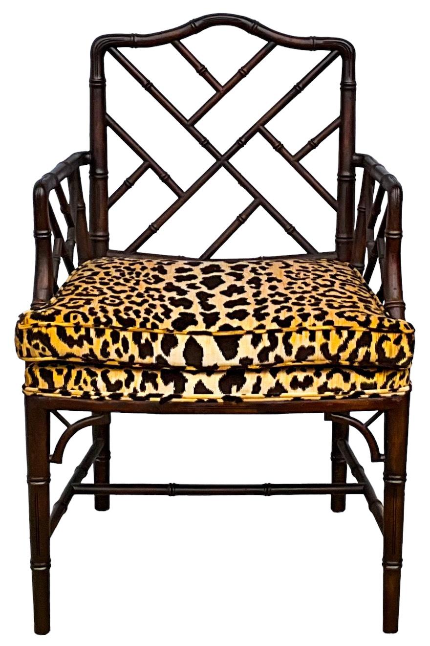 This is a timeless and versatile pair of Chinese Chippendale style carved fruitwood faux bamboo arm chairs in a new leopard velvet. They are unmarked and date to the 70s.