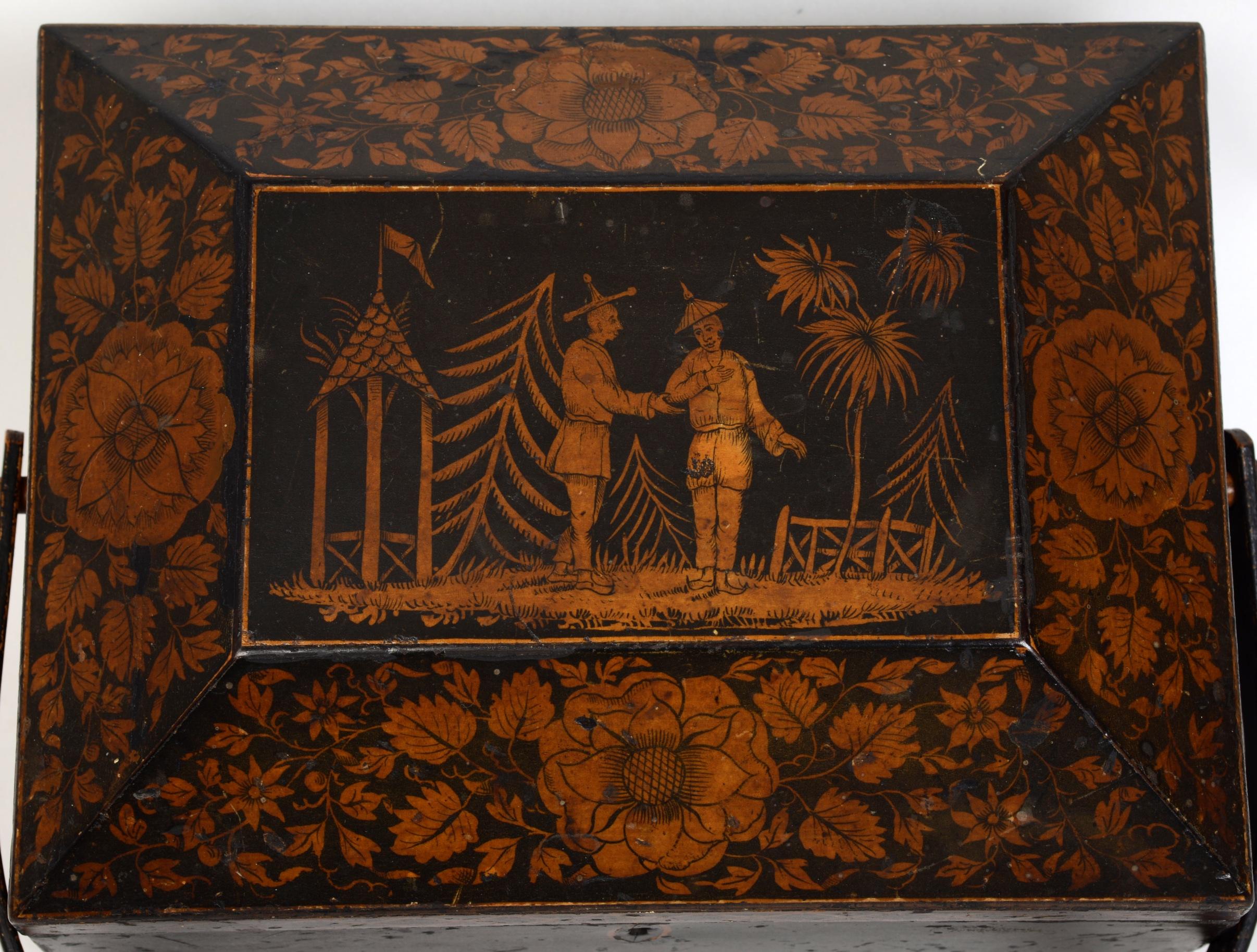 Regency chinoiserie decorated penwork sewing box with swing handle, circa 1810. With original paper lined interior. The central cartouche is decorated with a whimsical, imaginary, semi-tropical scene of two men wearing oriental clothing standing in