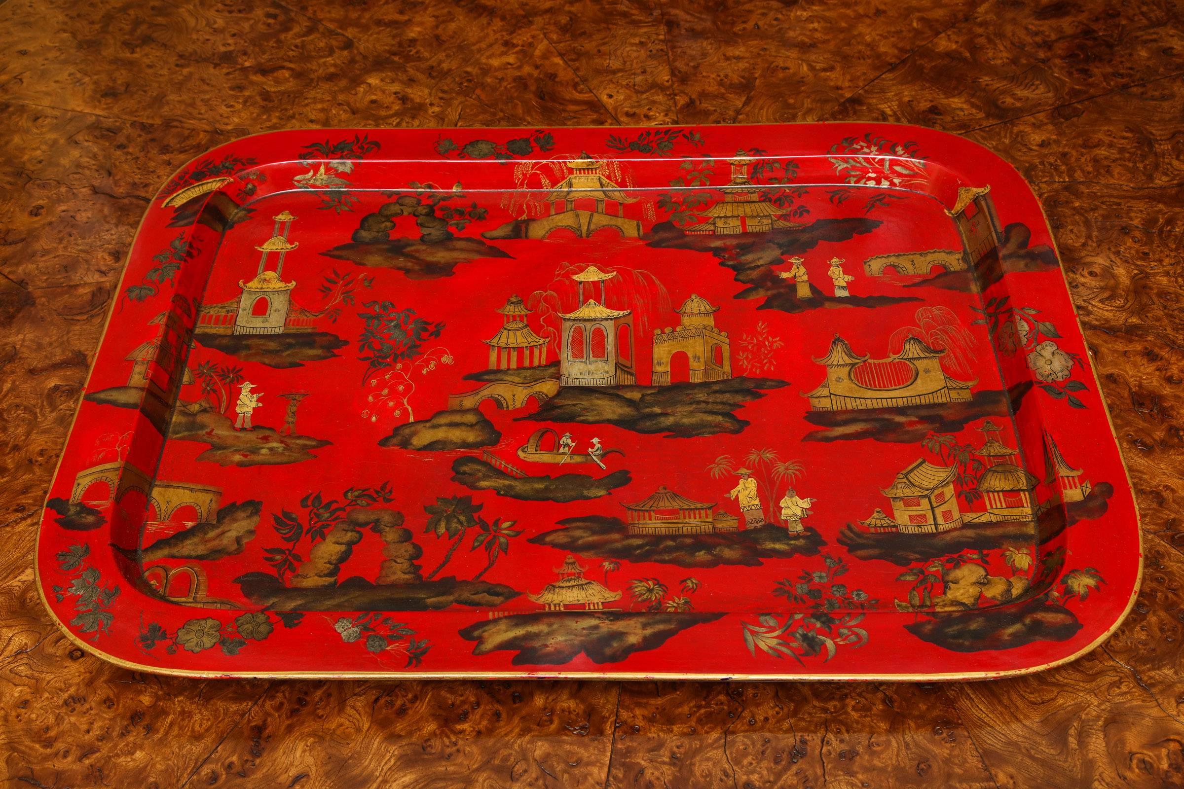 Regency chinoiserie scarlet papier mâché dished rectangular tray, decorated all over in gold and silver with figures upon imaginary islands and a boat in a watery seascape among pagodas, pavilions, rockwork, a bridge and flora and fauna English,