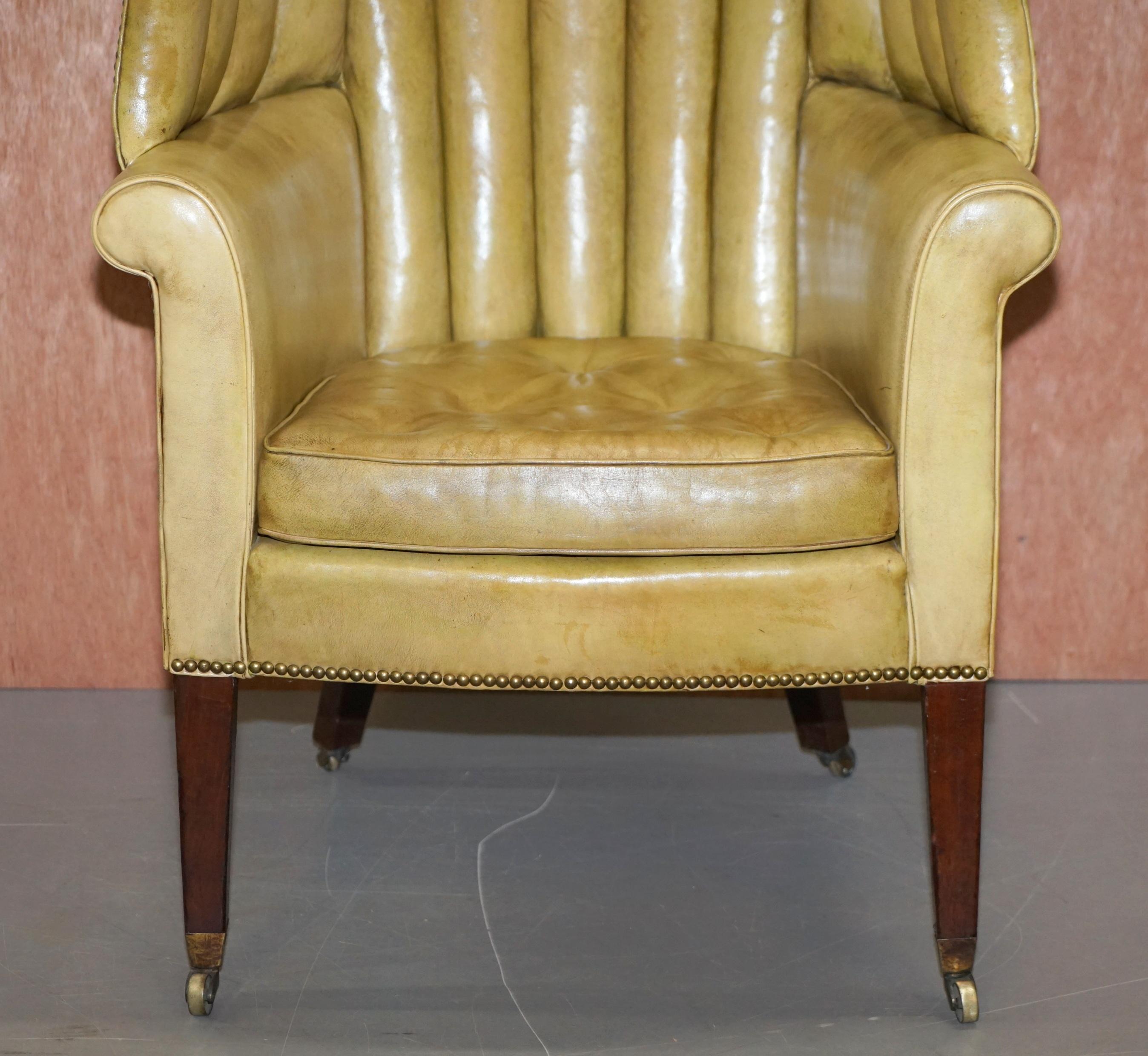 English Regency circa 1815 Fluted Barrel Back Leather Wing Armchair and Matching Stool For Sale