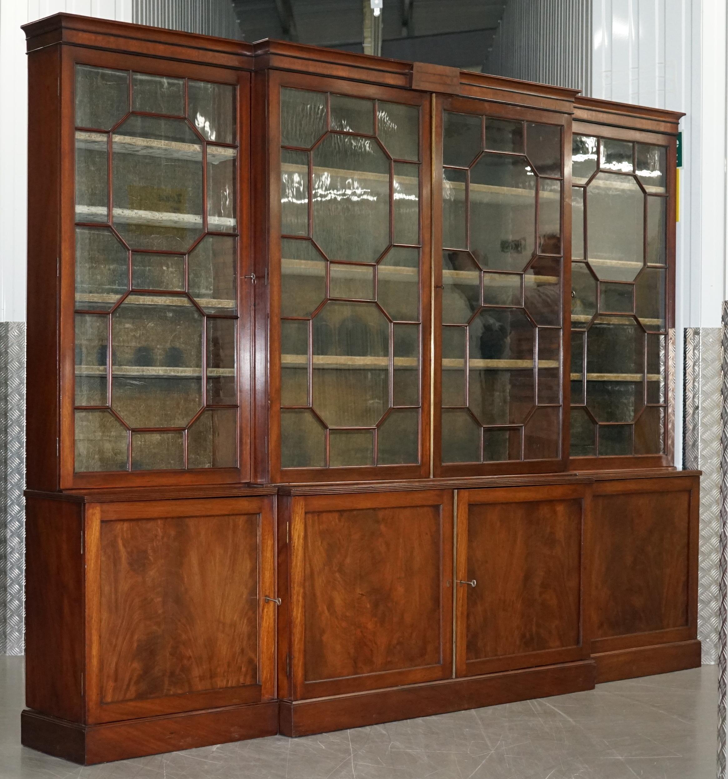 We are delighted to offer for sale this huge Regency circa 1820 Astral glazed flamed mahogany break front library bookcase or Pharmacy cabinet

This is a rare and desirable piece, its not often you come across quad bank astral glazed bookcases or