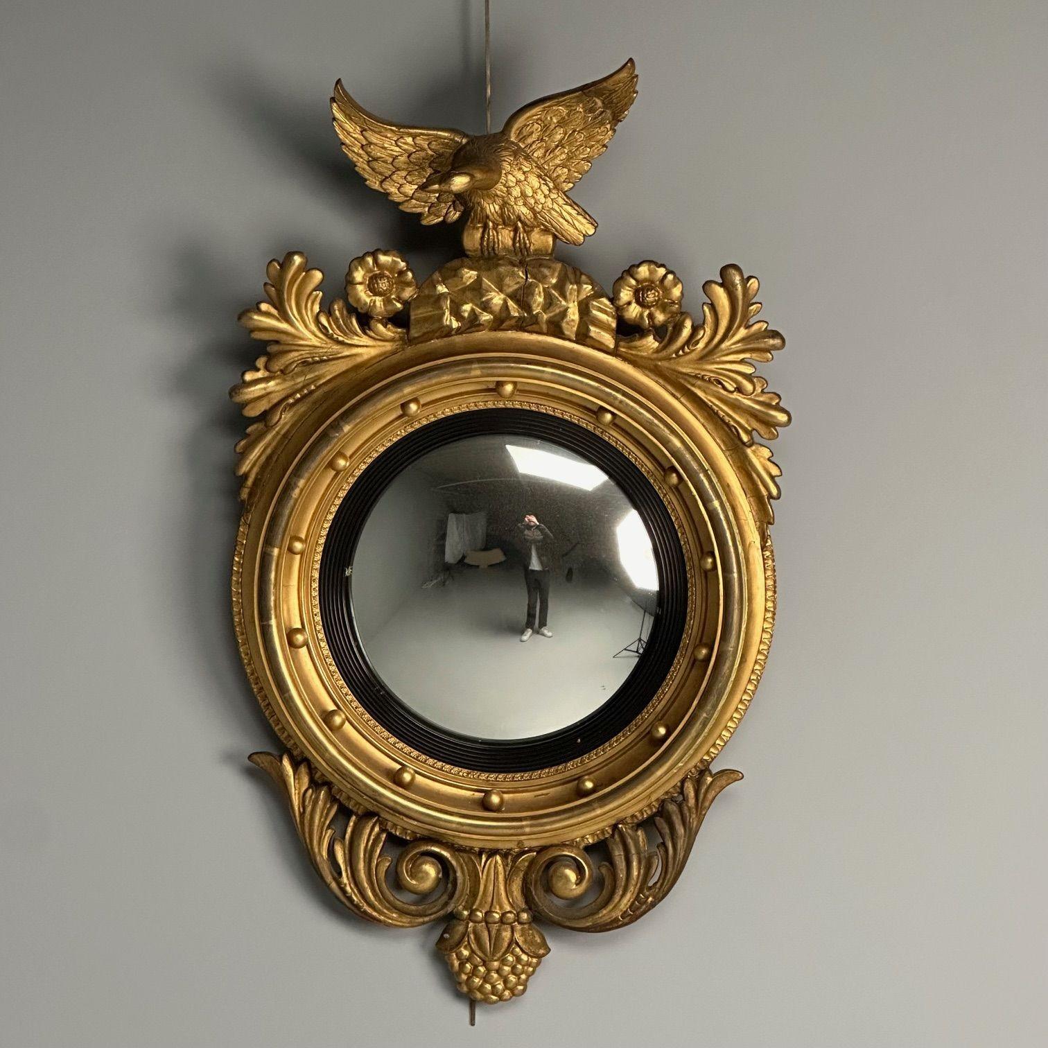 Regency, Circular Convex Wall Mirror, Giltwood, Eagle Motif, USA, 1950s

Finely carved giltwood circular convex mirror plate within an ebonized reeded slip and gilt foliate carved banding within a concave molded frame applied with balls surmounted