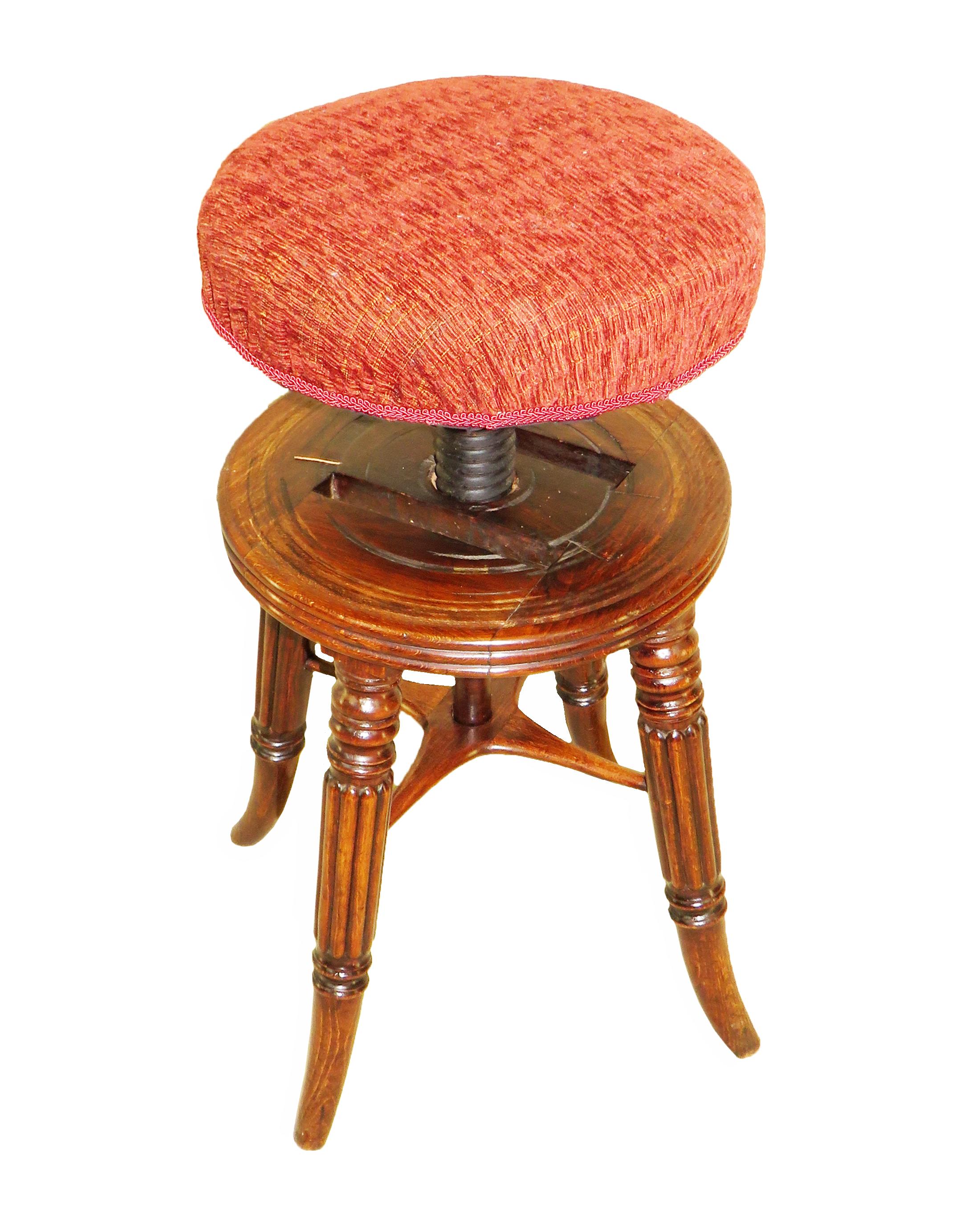 A fine quality regency period mahogany piano stool,
in the manner of Gillows, having circular adjustable
seat, over elegant turned and reeded legs terminating
on elegant swept feet united by cross stretcher

(This charming piano stool, which is