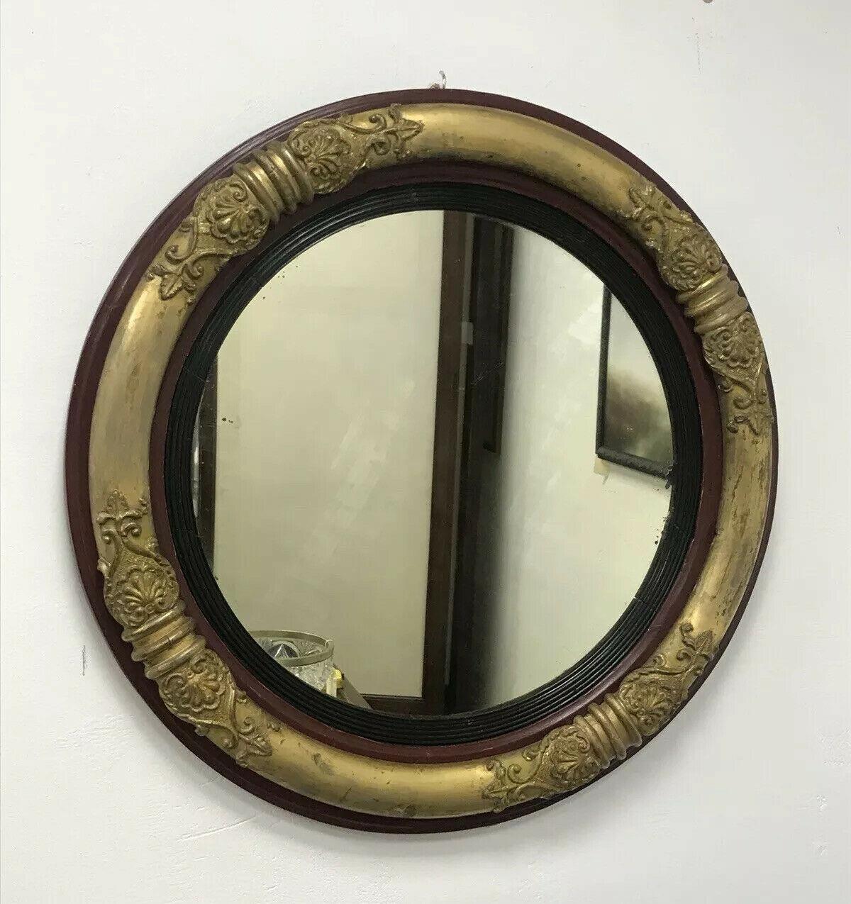 Original Regency circular wall mirror with ornate gold gilt frame.

   