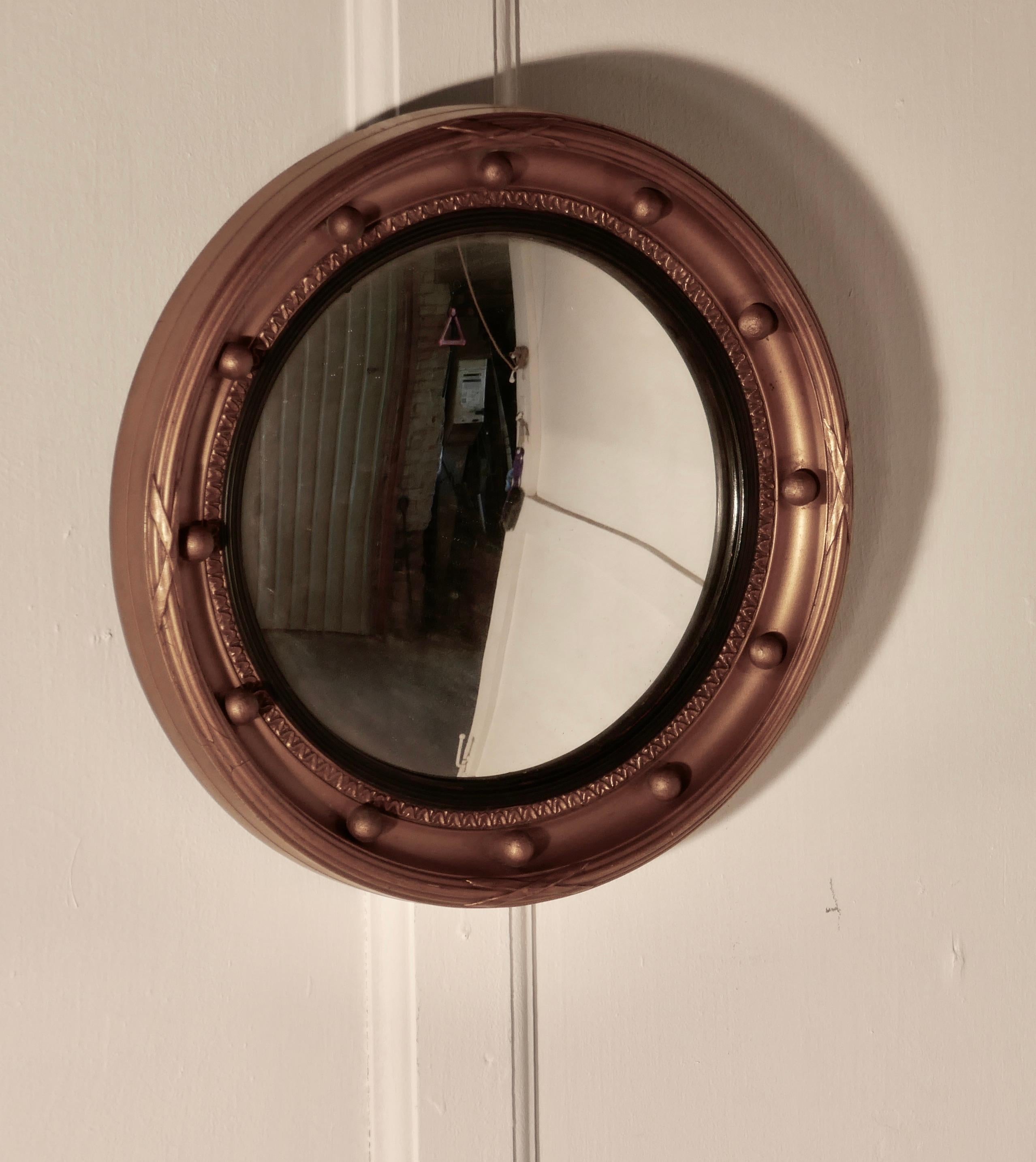 Regency convex gilt wall mirror 


This stunning mirror has a deep gilt frame decorated with spheres, the convex glass is held with a reeded ebony mount

The large 2.5” round frame is in sound condition as is the original convex looking