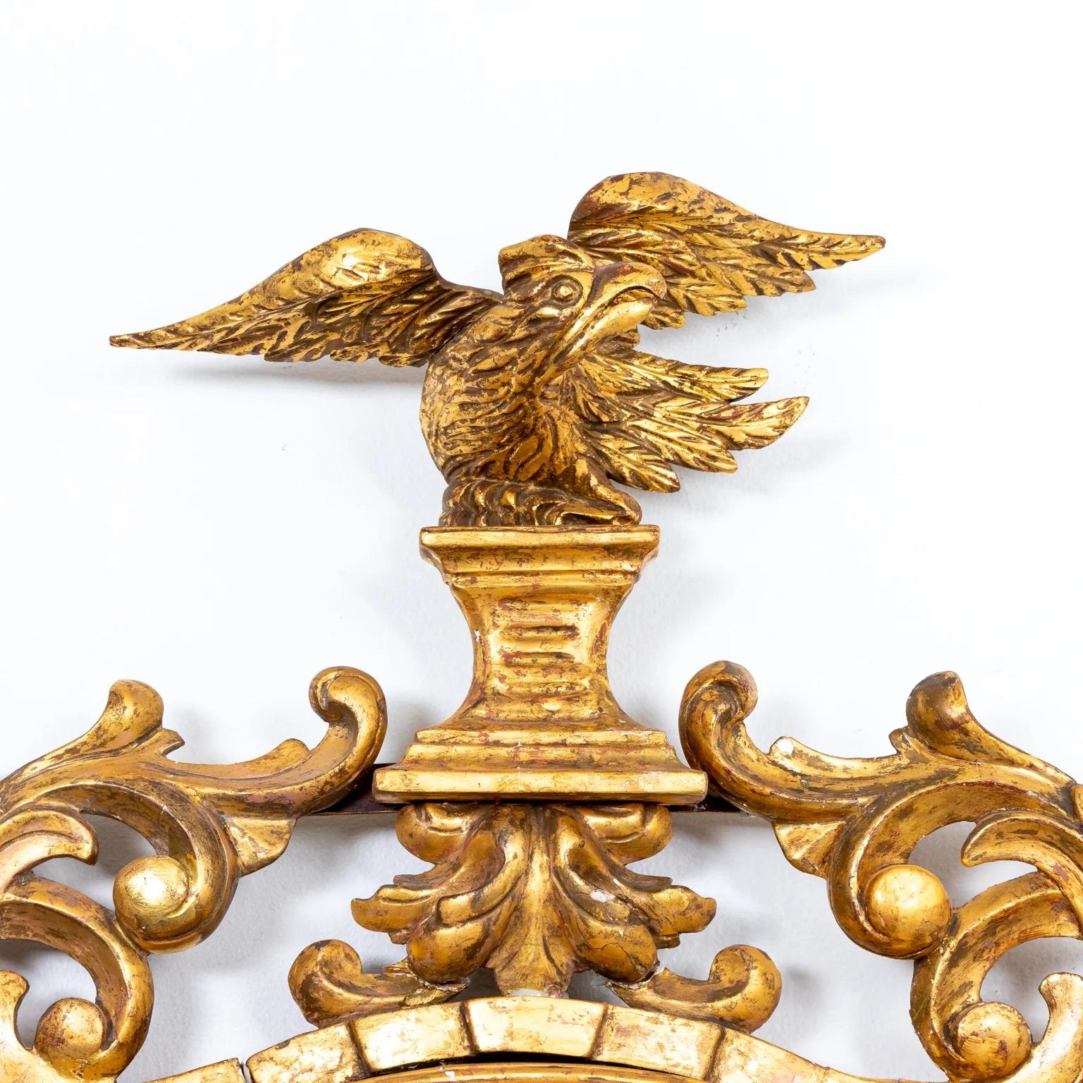 Regency encompasses period the giltwood ebonized convex liner. mirror with eagle and foliate crest. A group of 20 gilt ball form finials encompasses the ebonized liner. Please note of wear consistent with age.