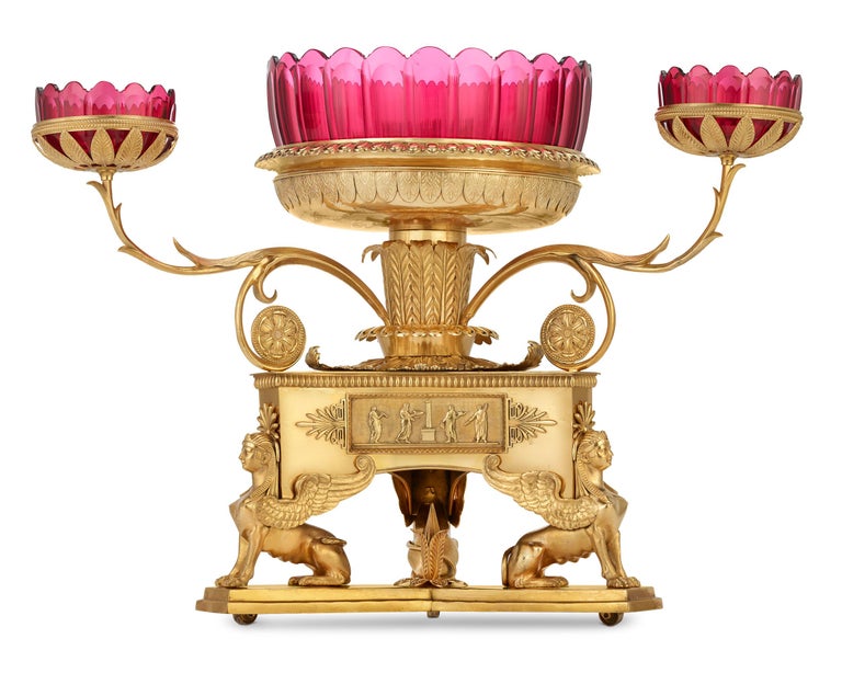 The grandeur of Regency design meets superb workmanship in this cast ormolu epergne. Three imposing sphinxes support each corner, reflecting the fascination with Egyptian antiquity brought about by the Napoleonic campaigns of the late 18th century,