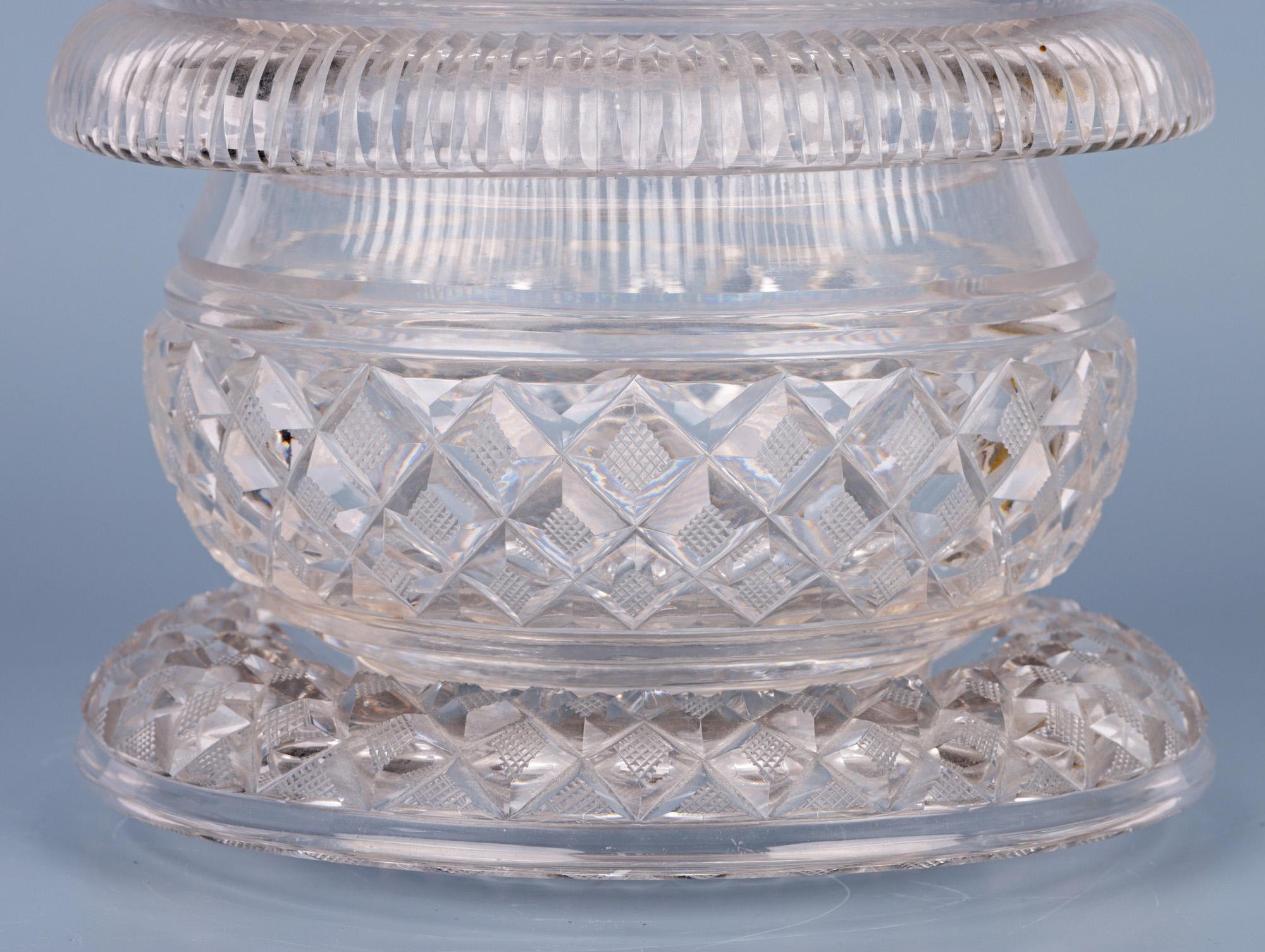 A very fine antique cut glass lidded butter dish on matching stand dating from around 1825. The butter dish is of wide rounded shape and has a narrow round cut foot which sits within the recess of the stand and is decorated with diamond and prism