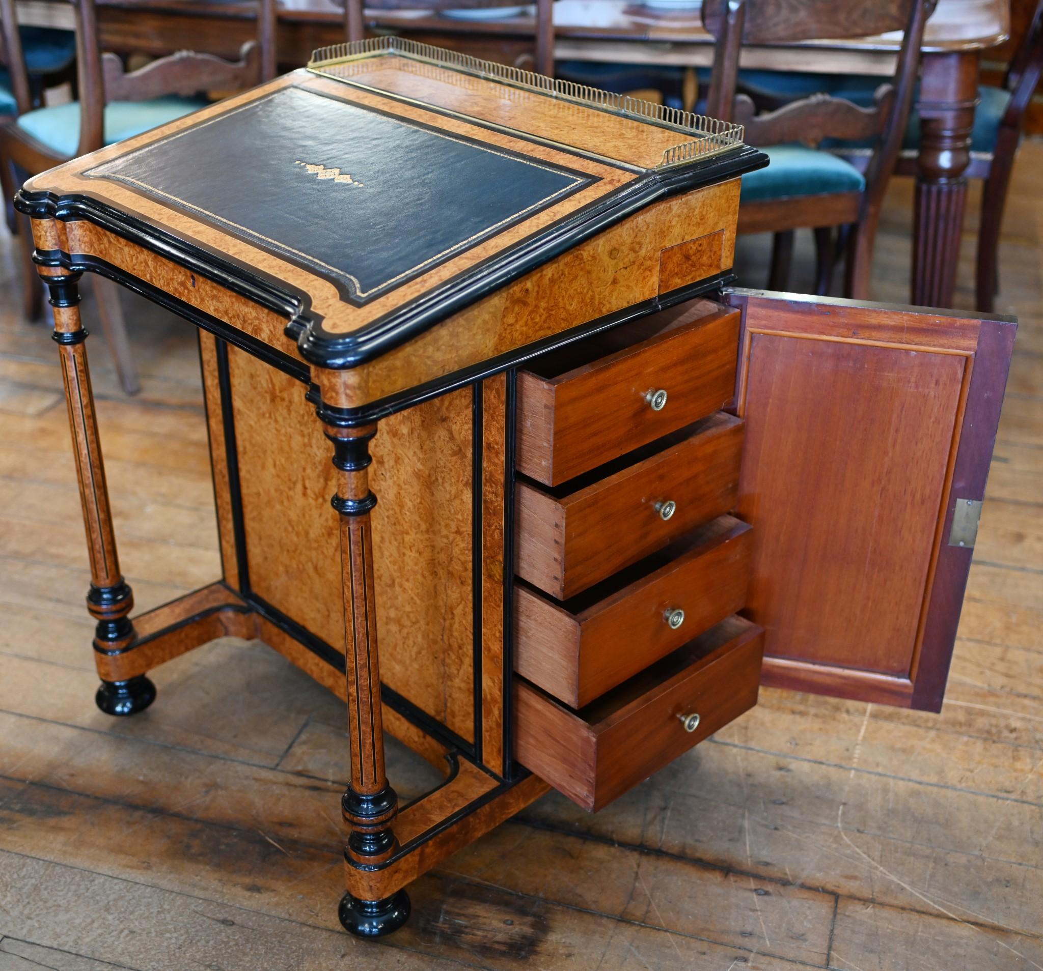 Elegant Regency Davenport desk
Gorgeous desk with distinctive light burr walnut finish and ebony accents
Black against the light brown really highlights the elegant design
Leather lined top opens up to reveal six little drawers and lockable storage