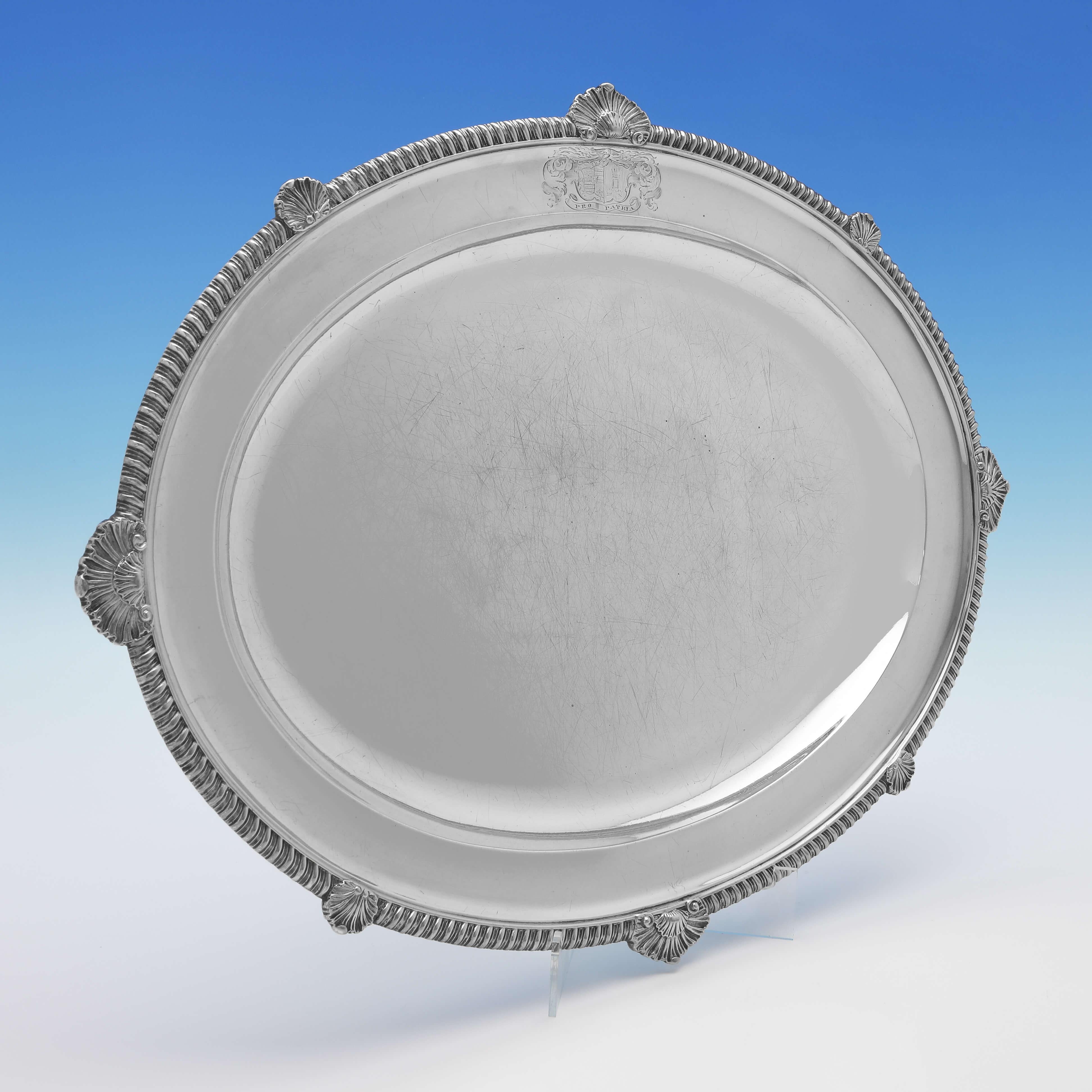 Hallmarked in London in 1822 by William Eley II, this very handsome pair of Antique, Sterling Silver Meat Dishes, are in the Regency taste, featuring shell and gadroon borders and an engraved coast of arms to each.

Each meat dish measures
