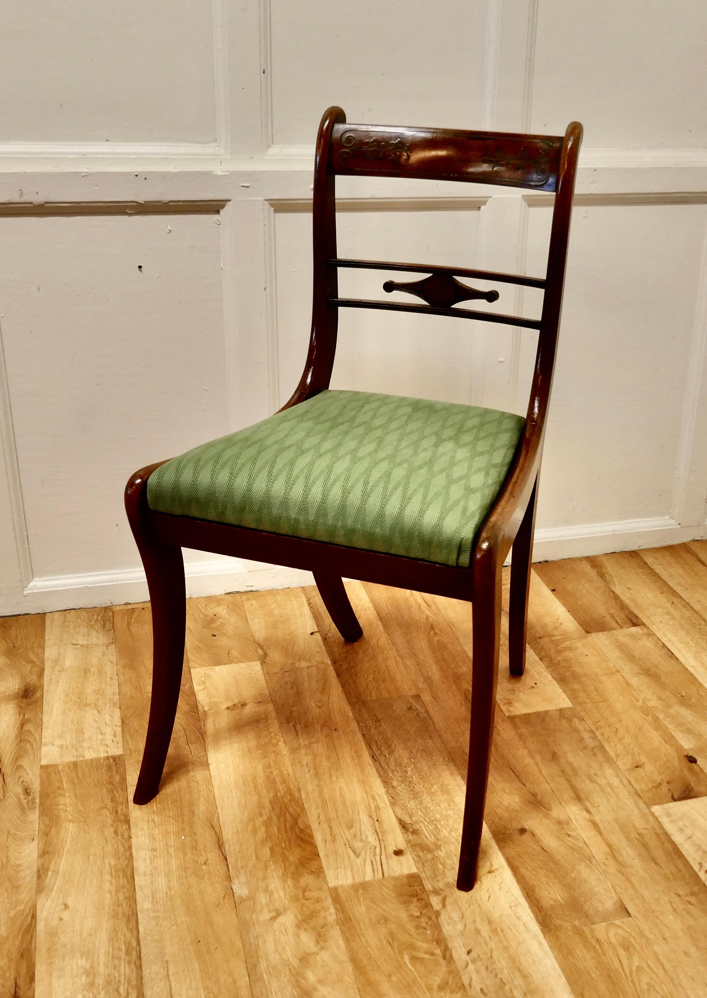Regency desk chair with brass inlay decoration
 
A very attractive chair which has a broad back top rail, this is intricately inlaid with Fine brass inlay
The chair has attractive sabre legs and a Trafalgar seat upholstered in a 2 tone