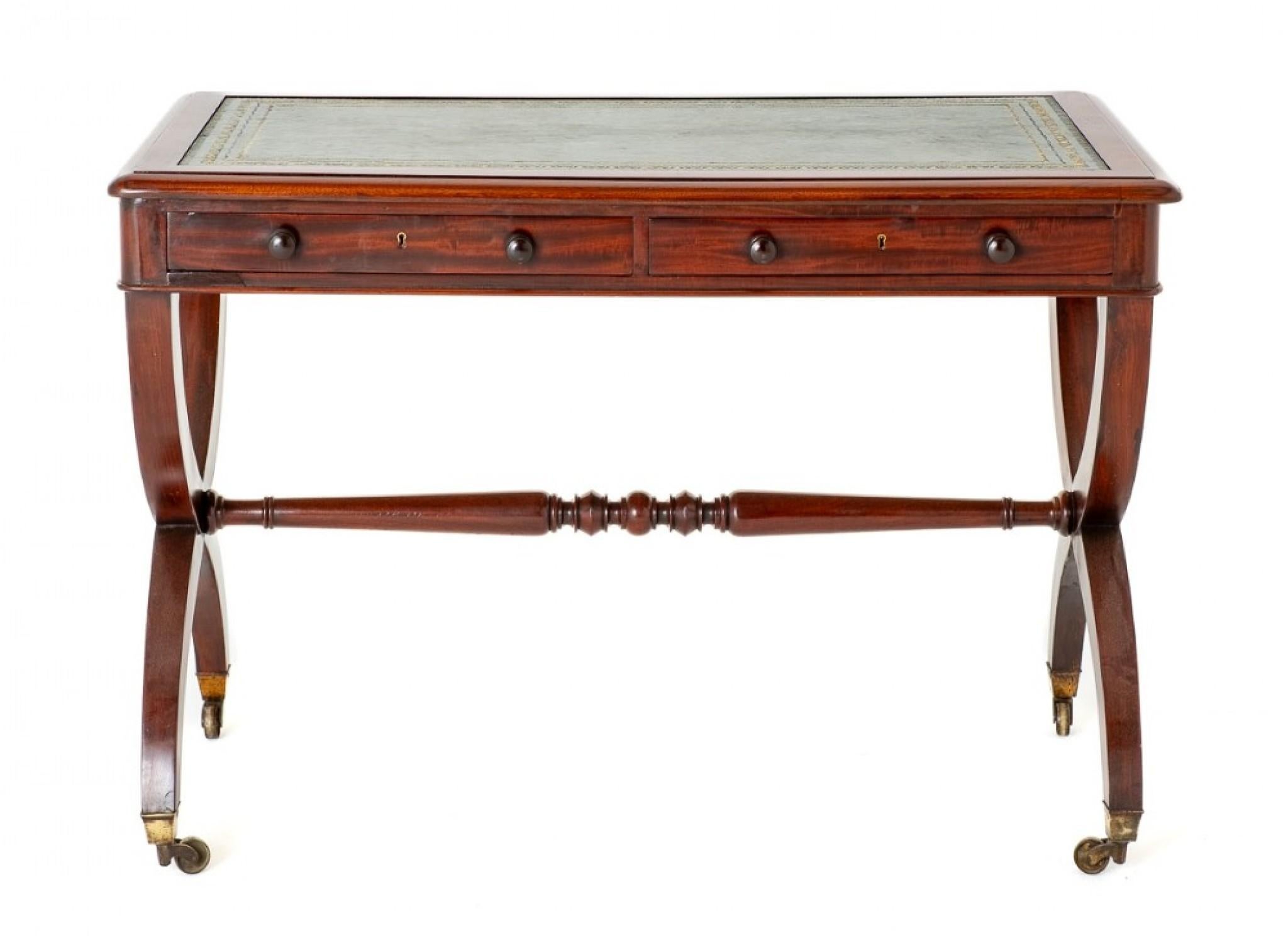 Regency Mahogany Writing Table.
This Quality Table is Raised upon Cross Frame Supports with Original Box Brass castors.
The Writing Table Features a Turned Stretcher, 2 x Oak Lined Drawers with Turned Knobs.
The Top of the Table Having a Fitted