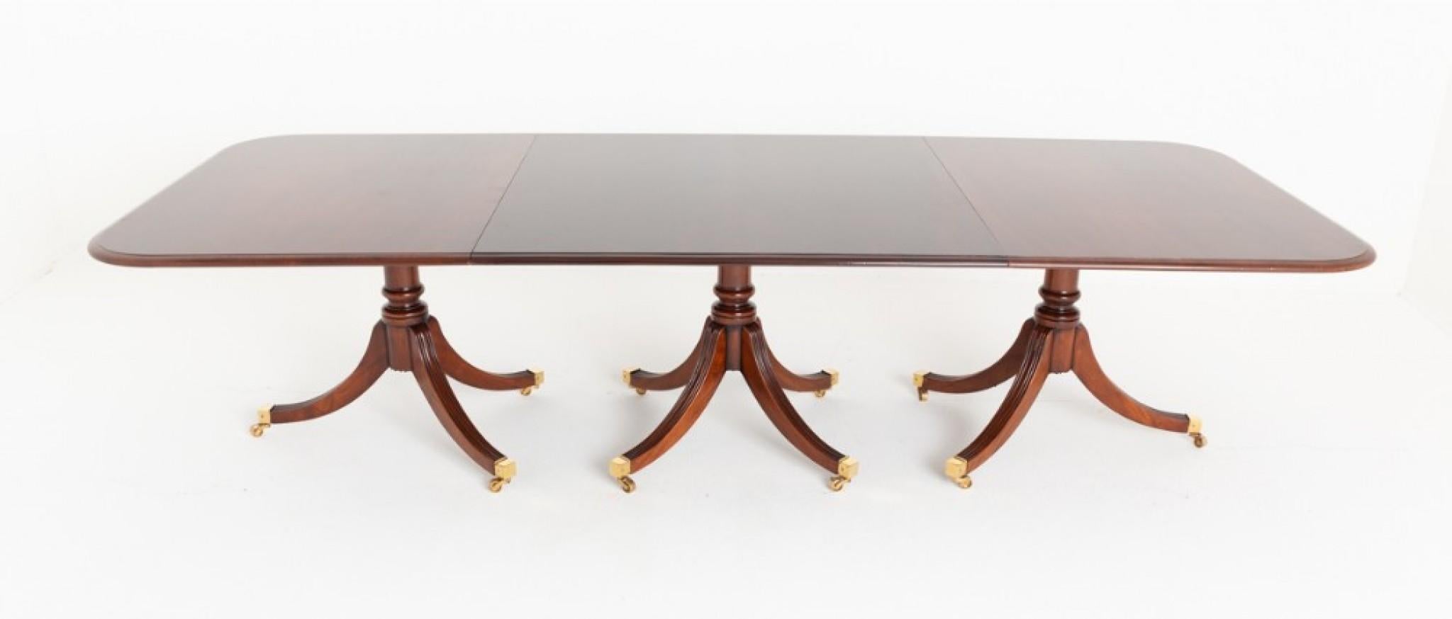 Regency Revival 16 - 18 seat mahogany 3 pedestal dining table.
This table is raised upon 3 pedestals.
Each pedestal having shaped and fluted legs with box castors and a turned column.
Circa 1920 The table extends by way of a telescopic pull out