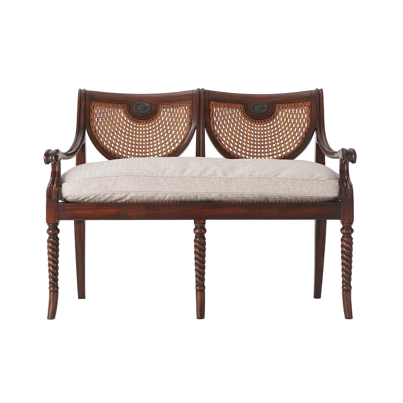 A hand-carved double chair back settee with caned back and seat, arms and silk cushion seat, on spiral turned legs. The original Regency.

Barley Houndstooth-UP4519 Fabric
Trim: Welting
Dimensions: 46