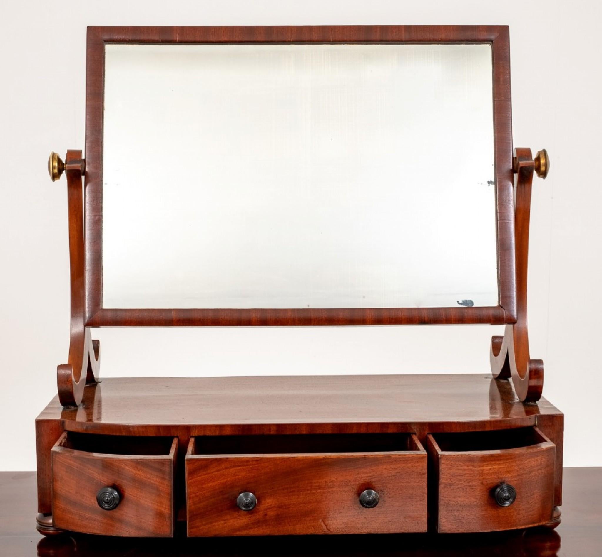 A Very Pretty Regency Mahogany Dressing Mirror.
19th century
Featuring 3 Shaped Mahogany Lined Drawers (note the fine dovetails)
Having turned Bun feet.
The Swivel Mirror Supported by Stylised Supports.
In Excellent Condition.
     
